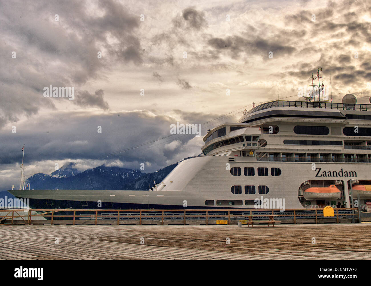 July 4, 2012 - Haines, Alaska, US - The ms Zaandam, a Holland America Line cruise ship, docked in Portage Cove at Haines, Alaska in early morning light. Dramatic clouds and the Chilkoot Mountain Range, part of the Coastal Range of mountains, form a spectacular backdrop. (Credit Image: © Arnold Drapkin/ZUMAPRESS.com) Stock Photo