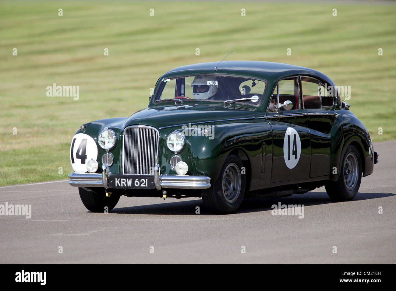 Goodwood Estate, Chichester, UK. 15th September 2012. Rowan Atkinson driving a Jaguar MkV11 during the St Mary's Trophy at the Goodwood Revival. The revival is a 'magical step back in time', showcasing a mixture of cars and aviation from the 40's, 50's and 60's and is one of the most popular historical motor racing events in the world. For more information visit www.goodwood.co.uk/revival. Stock Photo
