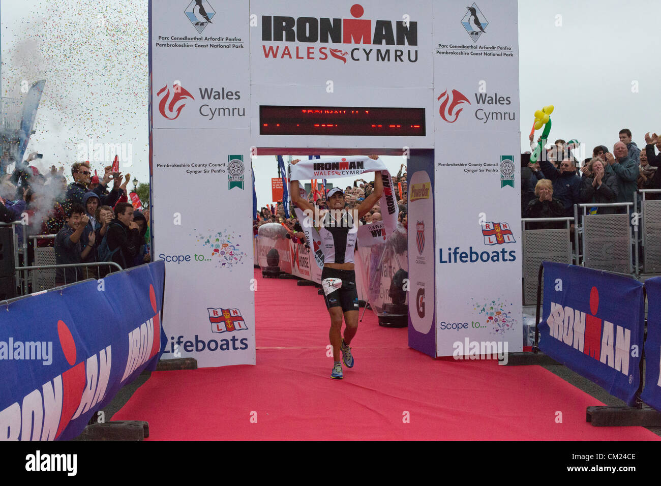 Athlete "Sylvain Rota" Winner running finishing line during ironman