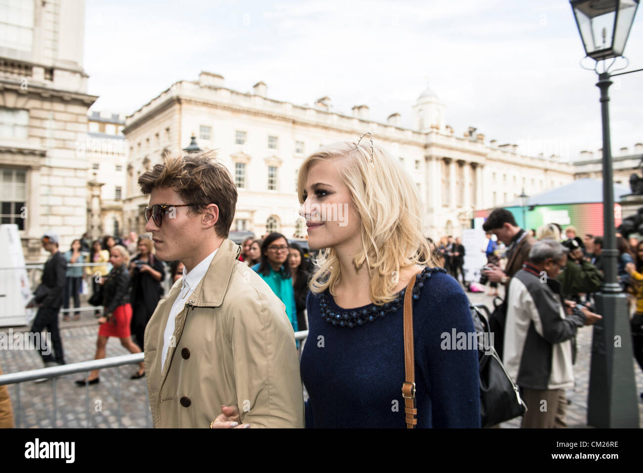 17th September 2012, UK. London Fashion Week at Somerset House, London. The famous and fashionable attend the shows or purely to hang out in the courtyard. Singer, Pixie Lott leaves with male friend after the show. Stock Photo