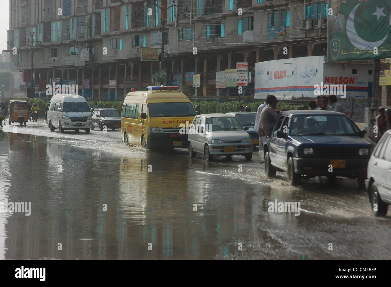 KARACHI, PAKISTAN, SEP 19 Commuters passes through stagnant drinking