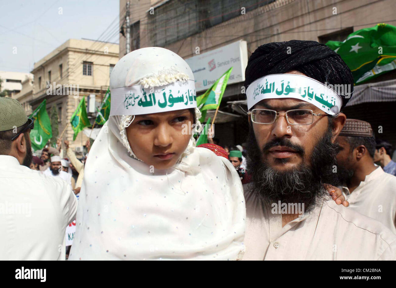 Supporters of Jamat-e-Ahle Sunnat are protesting against  blasphemy anti-Islamic movie released on the Internet by USA, during protest rally at M.A  Jinnah Road in Karachi on Wednesday, September 19, 2012. Stock Photo
