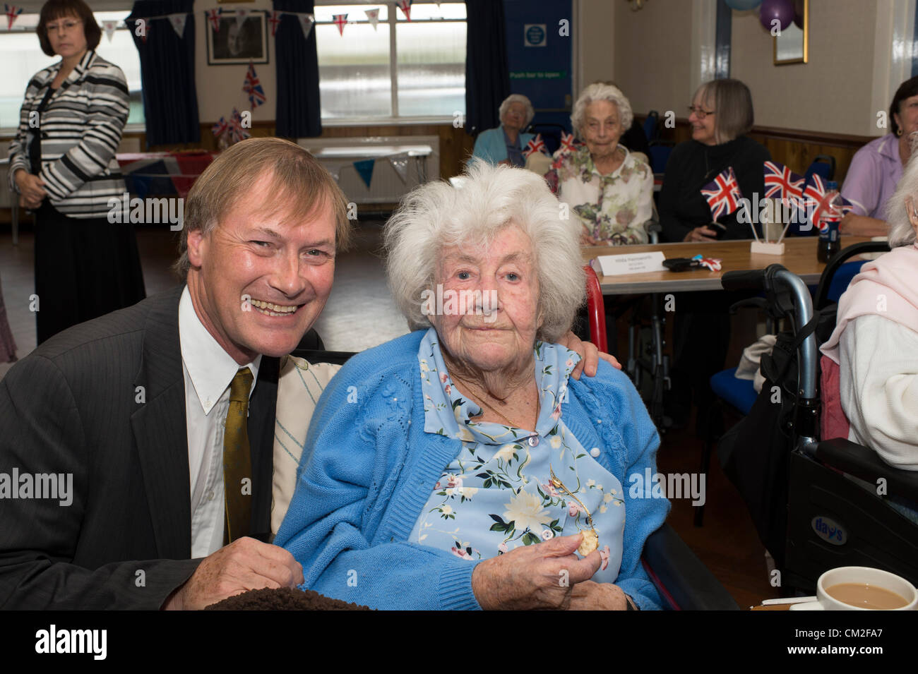 20th September 2012. Leigh on Sea, Essex, UK. The sixth annual Centenarian's Tea Party organised by Southend Conservative MP, David Amess. 14 centenarians attended the Conservative Club at Leigh for a tea party. 2009 saw 29 attend which is their record so far. The oldest attendee today was Ivy Marshall, 104 years old. Pictured here is David Amess MP with 101 year old Olive Fletcher. Stock Photo