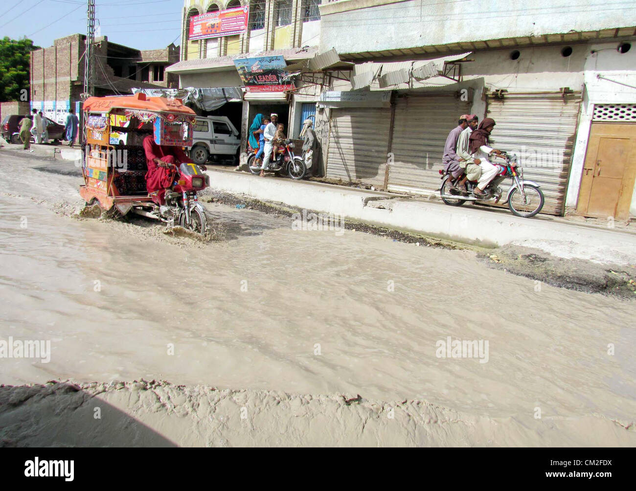 Commuter passes through stagnant flood water at Shikarpur-Jacobabad ...