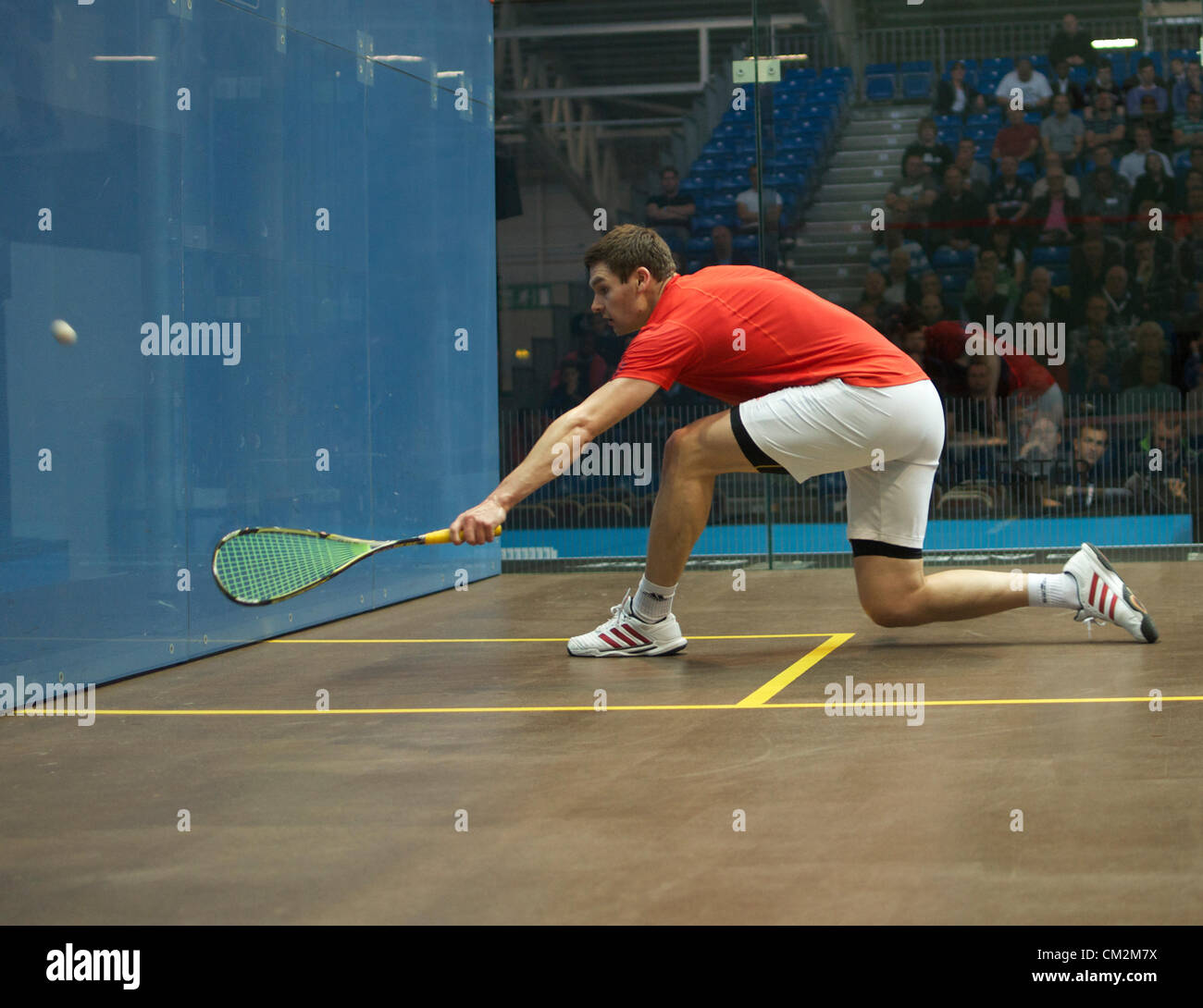 Adrian Waller (England) makes a backhand return during his match with Gregory Gaultier (France). Gaultier won the first round match 11-6.11-7.11-4 in the British Grand Prix at Sportcity, Manchester, UK 21-09-2012 Stock Photo