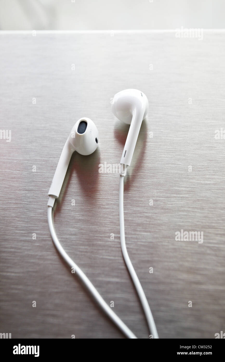 Inside a coffee shop, a newly released pair of Apple EarPods sit on a metal  countertop. The EarPods became available to public on Friday, September 21,  2012 Stock Photo - Alamy
