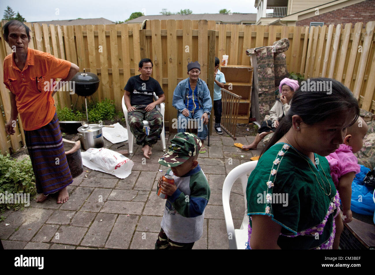 May 12, 2012 - Indianapolis, Indiana, U.S - In Indianapolis, Indiana a community of Karen and Karenni ethnic cultures, refugees from Myanmar (Burma) bordering with Thailand, share a new village much different from their native land.  Karenni ethnic Burmese refugee in the backyard at Lakeside Pointe apartments. (Credit Image: © Gary Dwight Miller/ZUMAPRESS.com) Stock Photo