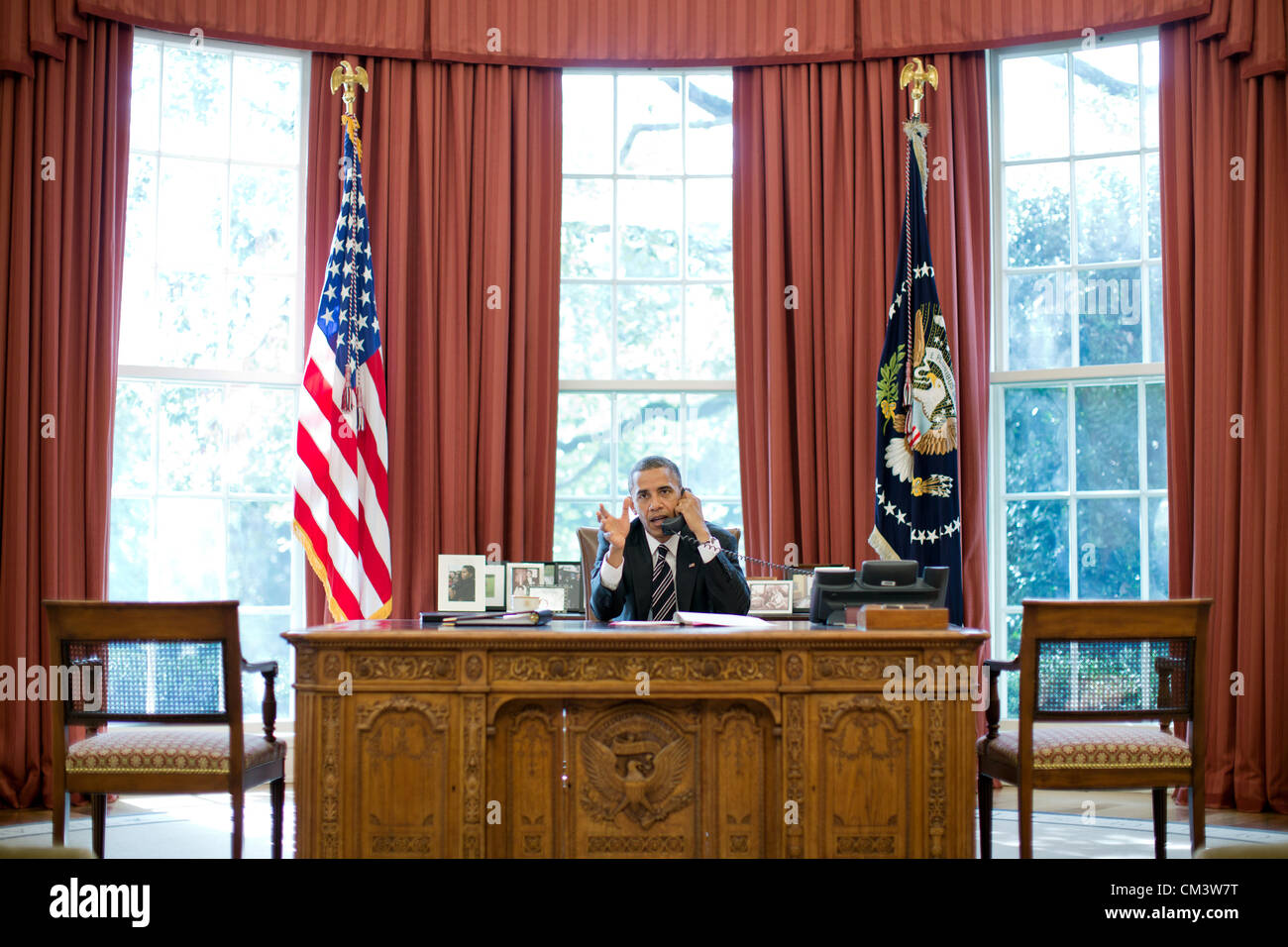 US President Barack Obama talks on the phone with Prime Minister Benjamin Netanyahu of Israel from the Oval Office September 28, 2012 in Washington, DC. Stock Photo