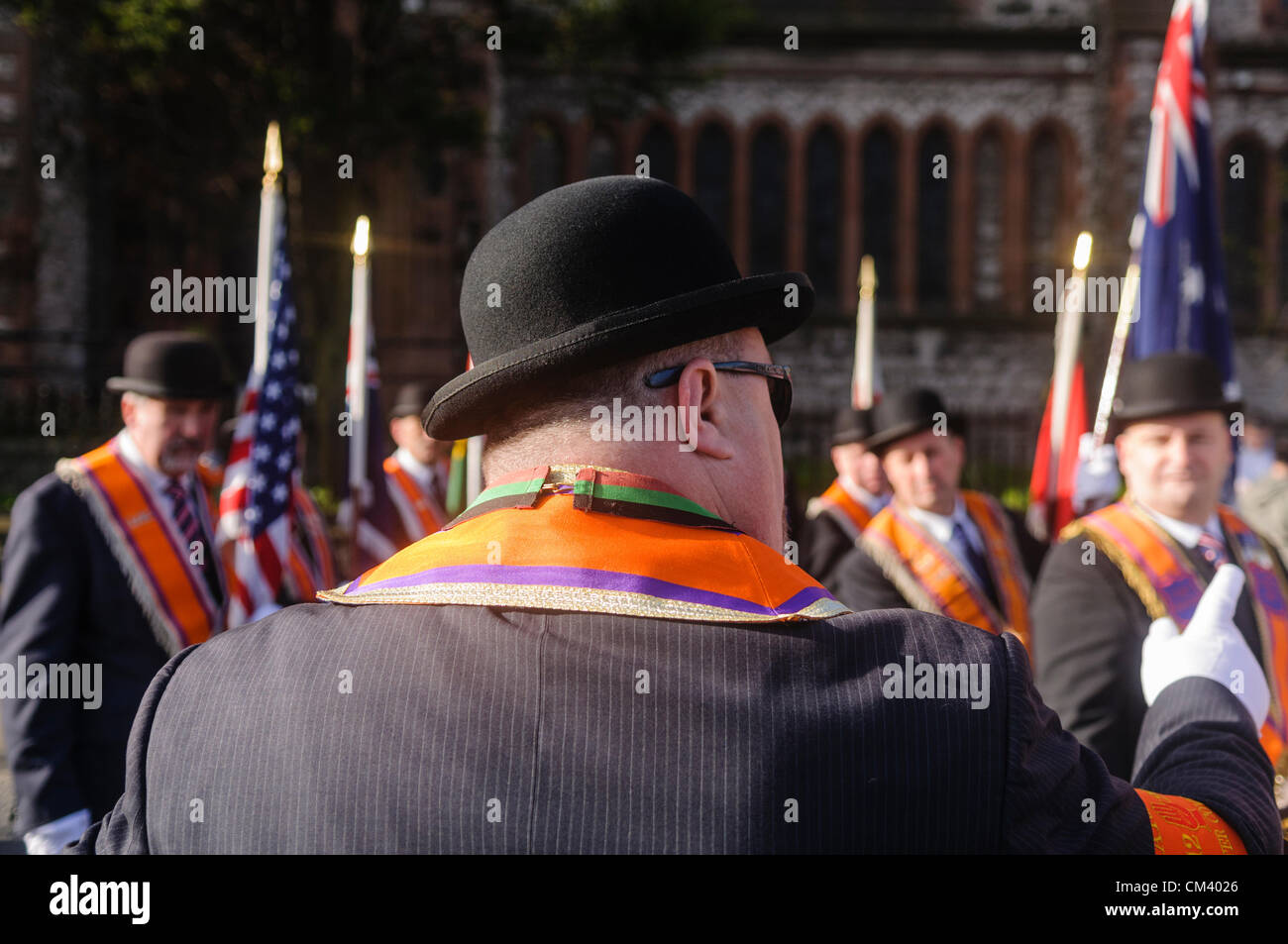 Orange Order official gives directions to fellow Orangemen during a briefing at the start of a parade Stock Photo
