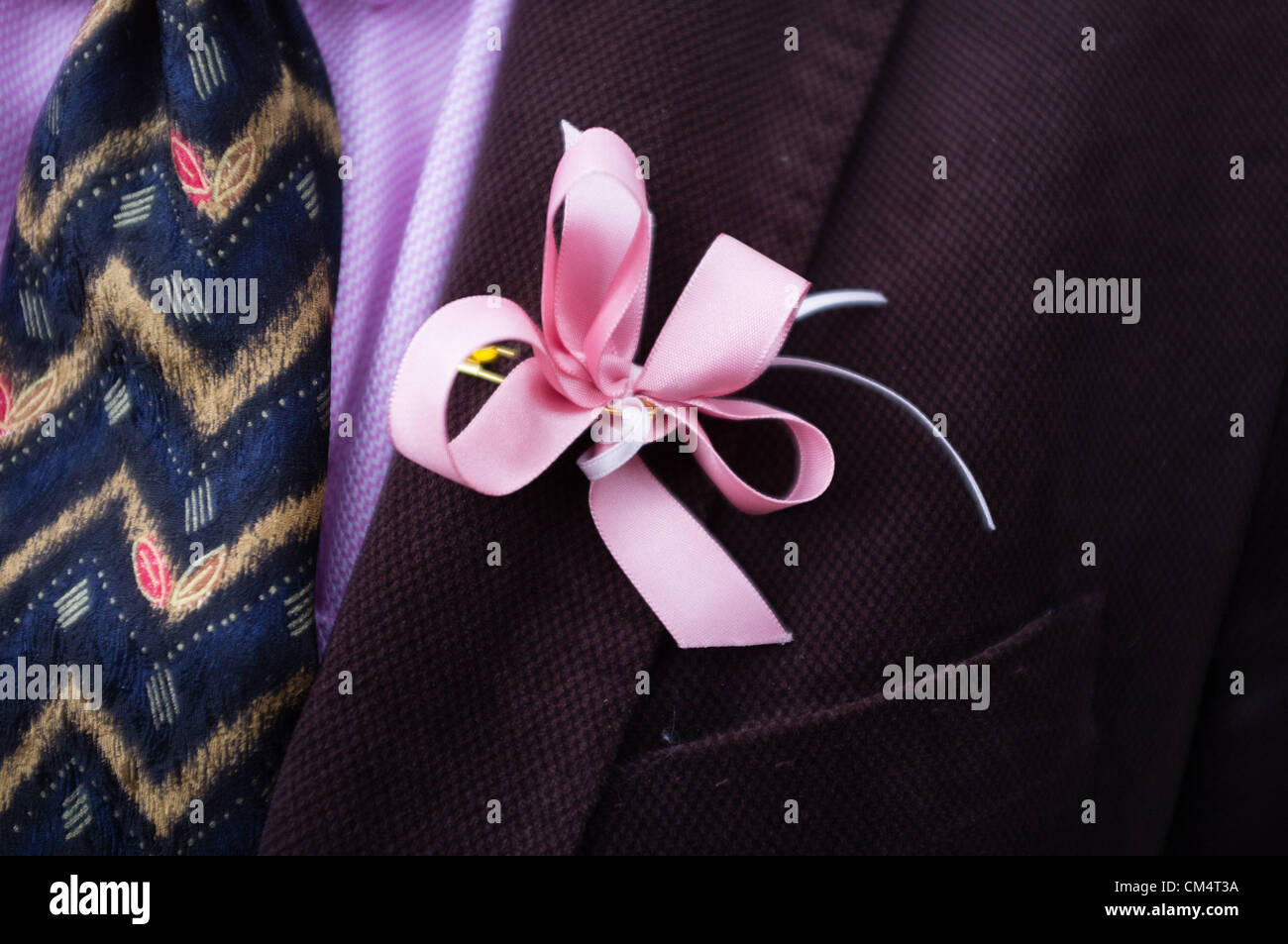 Machynlleth Wales UK, Oct 4 2021 A man wearing a pink ribbon that has become a visible symbol of support for the ongoing search for missing 5 year old girl APRIL JONES, abducted whilst playing near her house on the evening of Oct 1 2012 Stock Photo