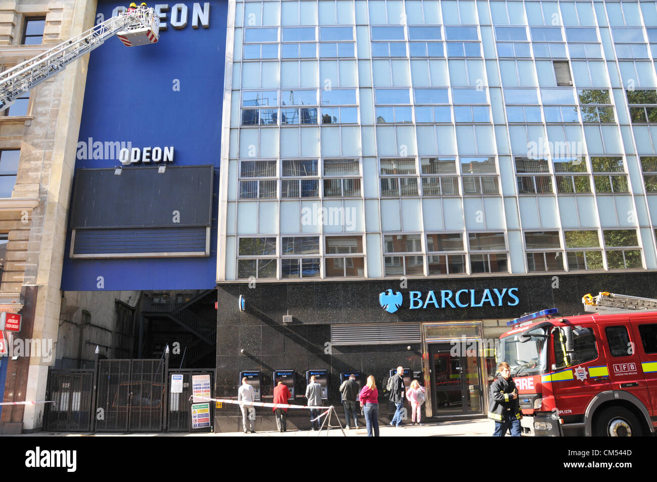 Charing Cross Road, London, UK. 6th October 2012. The metal coverings of the ODEON cinema on Charing Cross Road are removed by firemen after one of the signs nearly fell to the ground. Stock Photo