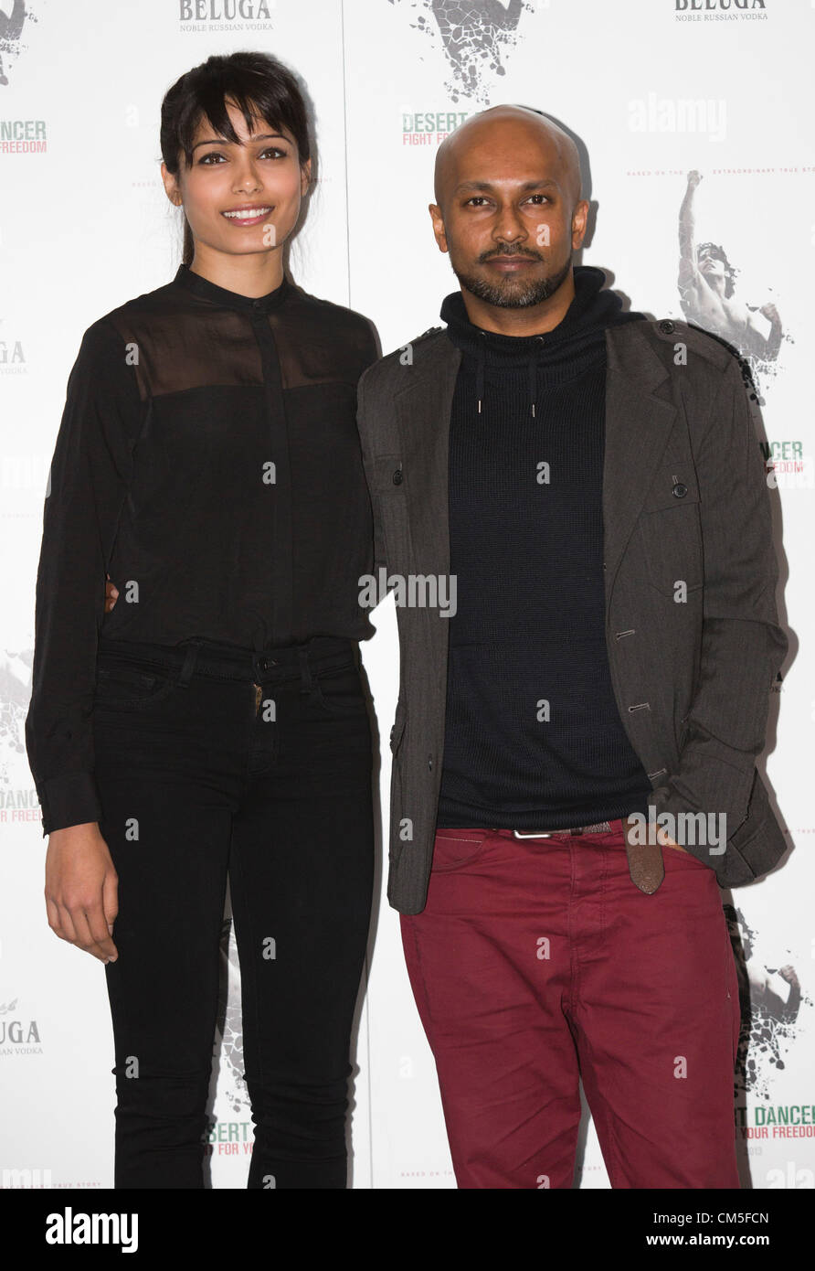 London, England, UK. Tuesday, 9 October 2012. Indian actress Freida Pinto with choreographer Akram Khan. Photocall for the film 'Desert Dancer' starring Indian actress Freida Pinto, Reece Ritchie and Tom Cullen at Sadler's Wells Theatre, London. The film was directed by Richard Raymond with dance choreography by Akram Khan. Stock Photo