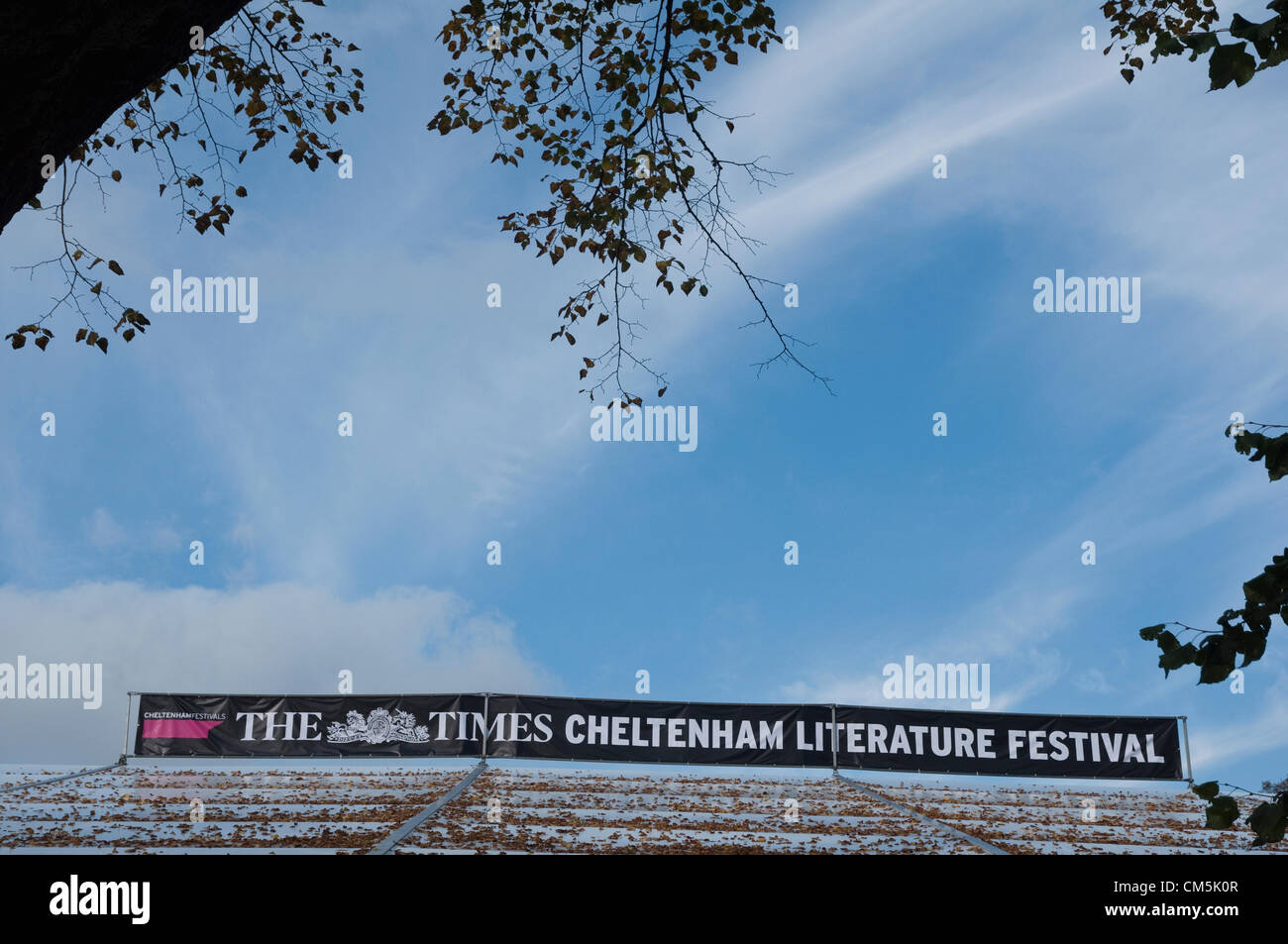 Cheltenham, UK. 9th October 2012. A banner on top of a tent covered in Autumn leaves advertising The Cheltenham Literature Festival sponsored by The Times newspapers which takes place 5th - 14th October 2012. Stock Photo