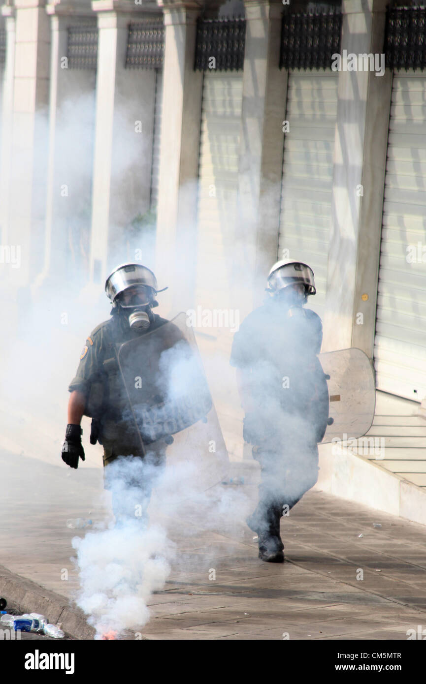 Athens, Greece. Tuesday 09 October 2012  Pictured: Riot police have been thrown flares by protesters in Syntagma Square, infront of the Greek Parliament.  Re: German Chancellor Angela Merkel has pledged her country's continuing support to Greece, during her first visit to Athens since the eurozone crisis erupted nearly three years ago.  Mrs Merkel said Greece had made good progress in dealing with its vast debt but that it was on a 'difficult path'.  Thousands of people who blame Germany for forcing painful austerity measures on Greece are protesting in Athens.  Police have used teargas and st Stock Photo