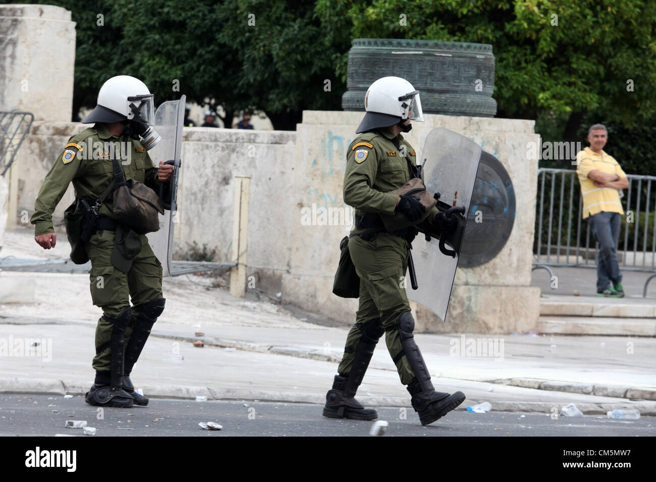 Athens, Greece. Tuesday 09 October 2012  Pictured: Riot police in Syntagma Square, infront of the Greek Parliament.  Re: German Chancellor Angela Merkel has pledged her country's continuing support to Greece, during her first visit to Athens since the eurozone crisis erupted nearly three years ago.  Mrs Merkel said Greece had made good progress in dealing with its vast debt but that it was on a 'difficult path'.  Thousands of people who blame Germany for forcing painful austerity measures on Greece are protesting in Athens.  Police have used teargas and stun grenades against demonstrators.  Co Stock Photo