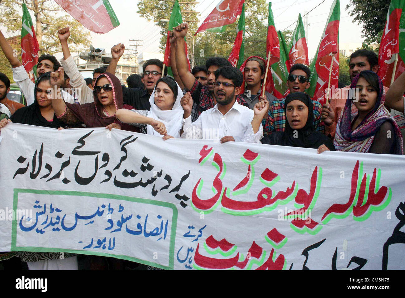 Activists of Insaf Students Federation (ISF) chant slogans  against attack on Malala Yousaf Zai during a protest demonstration at Lahore press club on  Wednesday, October 10, 2012. Malala Yousaf Zai, a child rights activist and National Peace  Award winner, was critically injured, along with another girl student, after a gunman shot her on  Tuesday in Mingora town of district Swat while she returning home from school on a van. Stock Photo