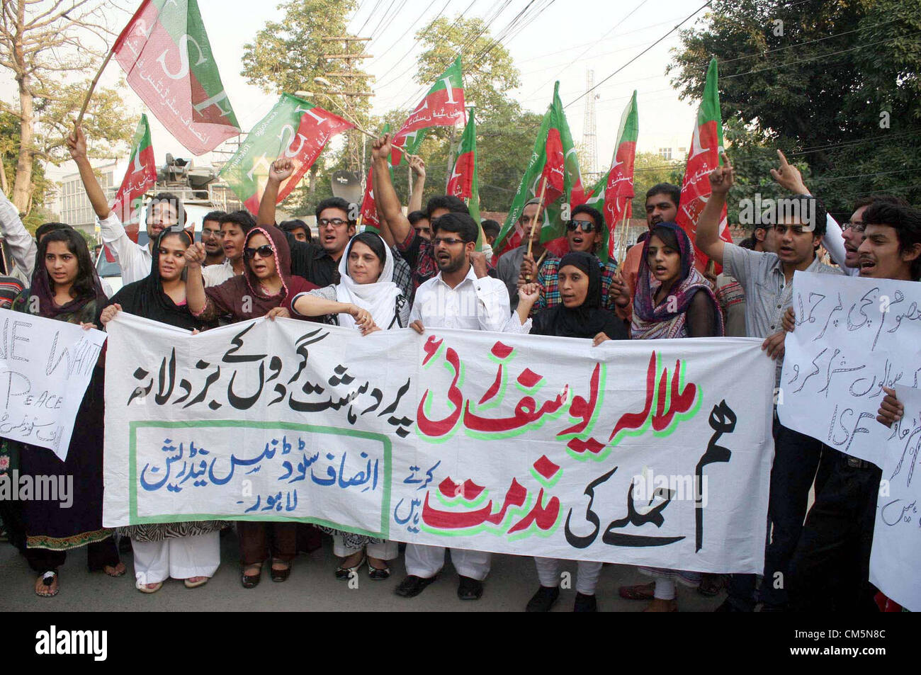 Activists of Insaf Students Federation (ISF) chant slogans  against attack on Malala Yousaf Zai during a protest demonstration at Lahore press club on  Wednesday, October 10, 2012. Malala Yousaf Zai, a child rights activist and National Peace  Award winner, was critically injured, along with another girl student, after a gunman shot her on  Tuesday in Mingora town of district Swat while she returning home from school on a van. Stock Photo