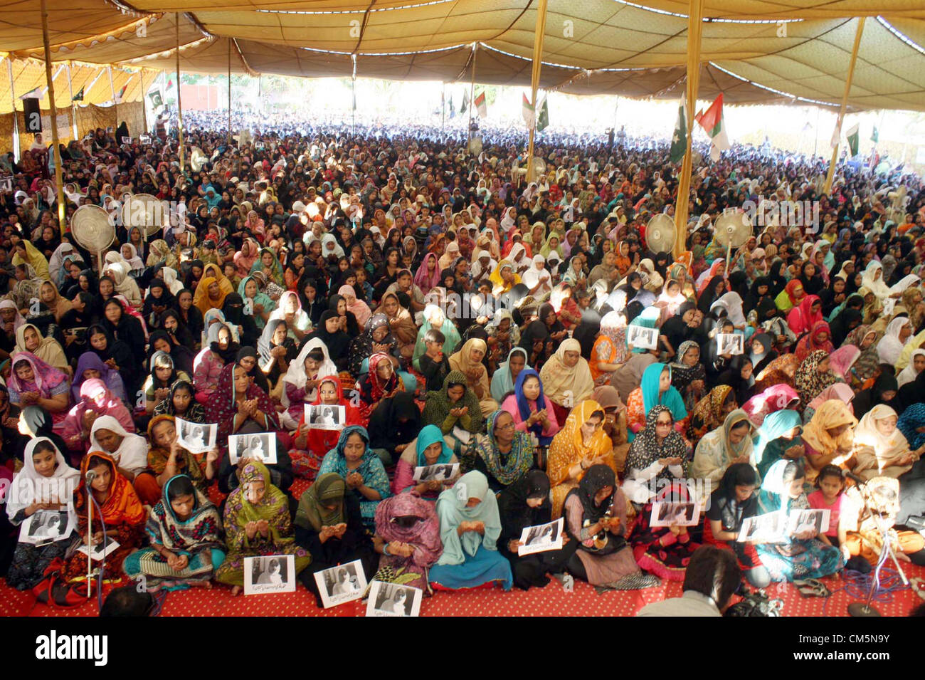 Women prayer for Malala Yousaf Zai during a pray  ceremony held at Jinnah Ground organized by Muttehda Qaumi Movement (MQM), in Karachi  on Wednesday, October 10, 2012. Malala Yousaf Zai, a child rights activist and National Peace  Award winner, was critically injured, along with another girl student, after a gunman shot her on  Tuesday in Mingora town of district Swat while she returning home from school on a van. Stock Photo