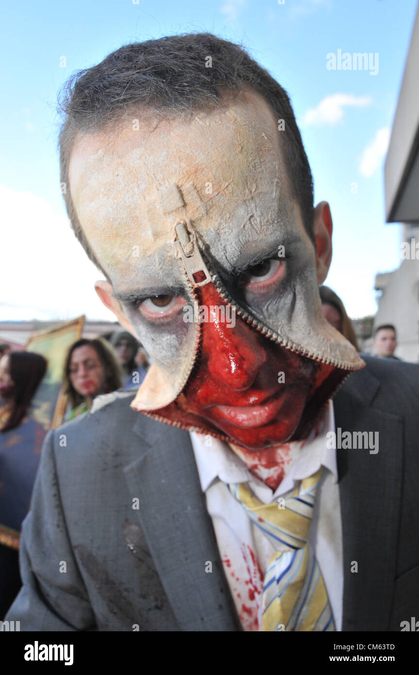 Southbank, London, UK. 13th October 2012. A zip faced 'Zombie' near the National Theatre. World Zombie Day, a Zombie themed pub crawl through central London. Hundreds of people dressed as Zombies make their way through London on a day long charity pub crawl. Stock Photo