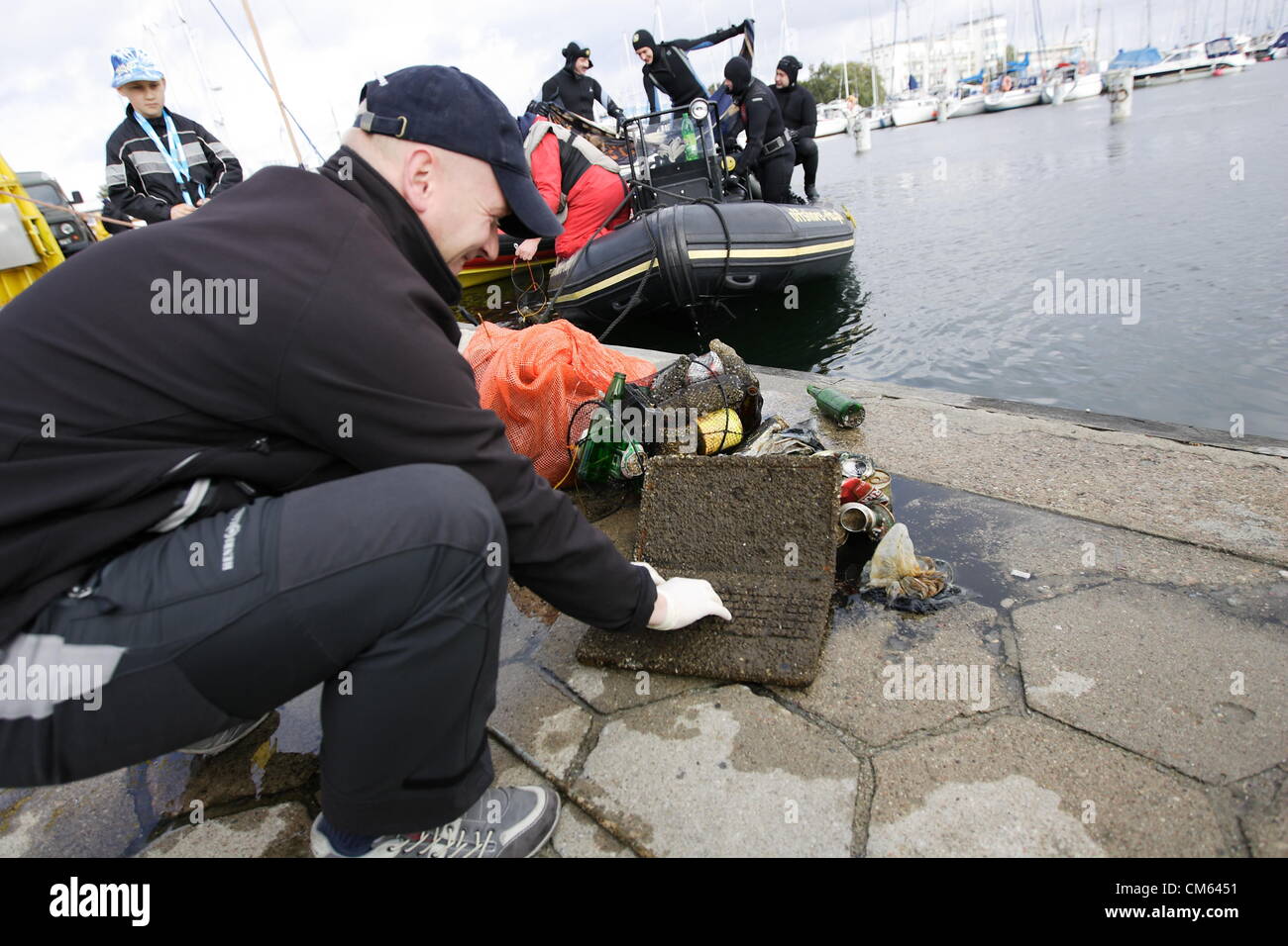 Gdynia, Poland 13th, October 2012 Eco-diving day 2012 . Over 100 divers takes part in the cleaning the Baltic Sea bottom near the Gdynia city marina and municipal beach. Among pile of rubbish they found few cellphones, laptop, camcorder and one satellite dish. Stock Photo