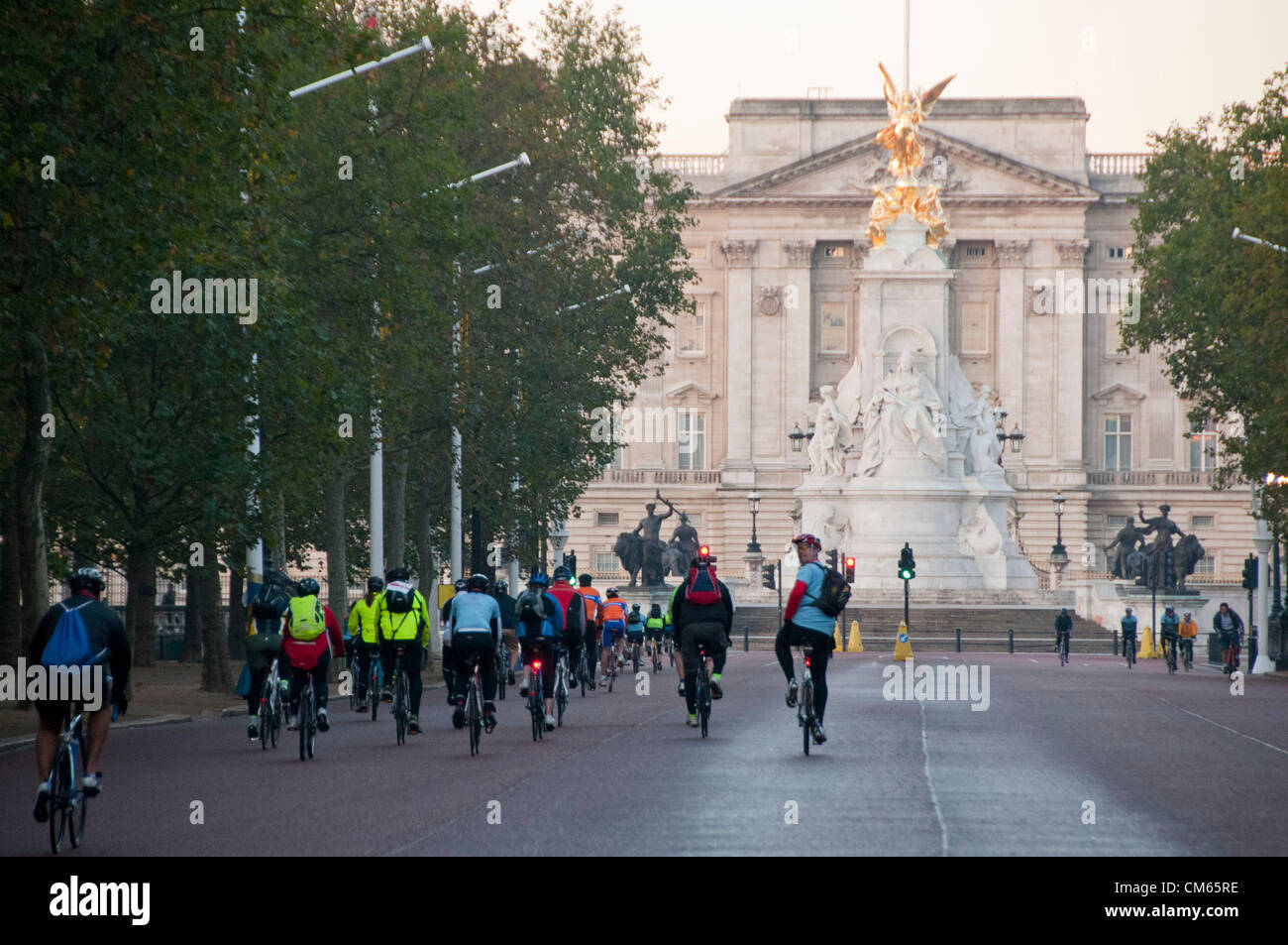 London, UK. 14/10/12. Cyclists travelling up the Mall to pass Buckingham Palace at the beginning