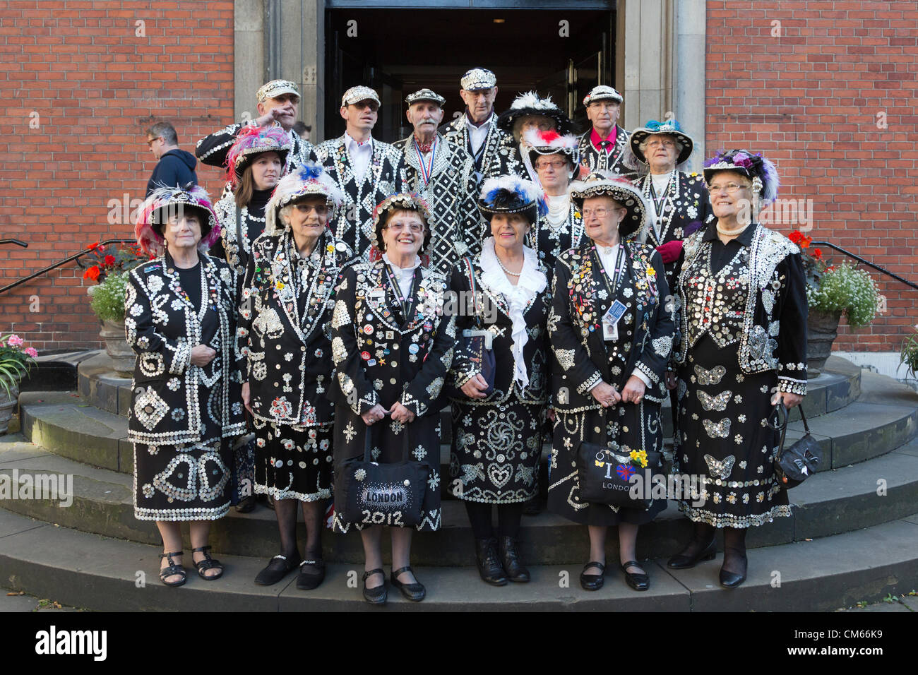 Pearly Kings & Queens from the Pearly Kings & Queens Society gather at St. Paul's Church in Covent Garden to celebrate the annual Harvest Festival. Stock Photo