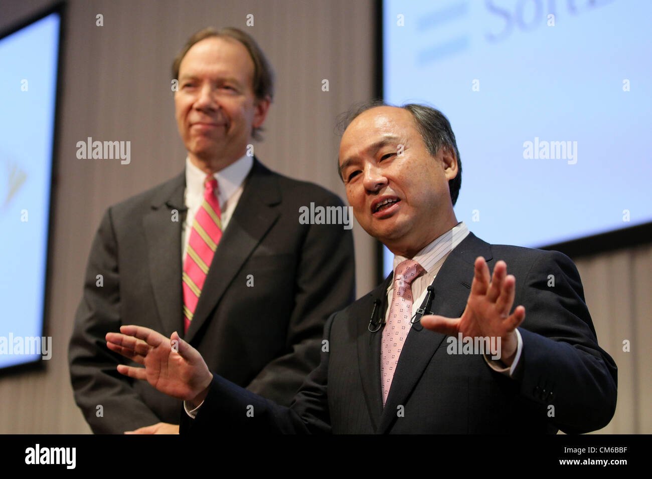 October 15, 2012, Tokyo, Japan - Softbank Corp. President Masayoshi Son (R) speaks to the media at the end of their media conference in Tokyo on Monday, October 15, 2012. Son announced that Japanese mobile Internet company Softbank has reached a deal to acquire Sprint Nextel Corp., the third-largest mobile carrier in the U.S. for $20 billion. The deal enables Softbank to establish an operating base as one of the largest mobile Internet companies in the world, with combined mobile telecom service revenues that will rank it third amongst global operators. Softbank aims to enhance Sprint's compet Stock Photo