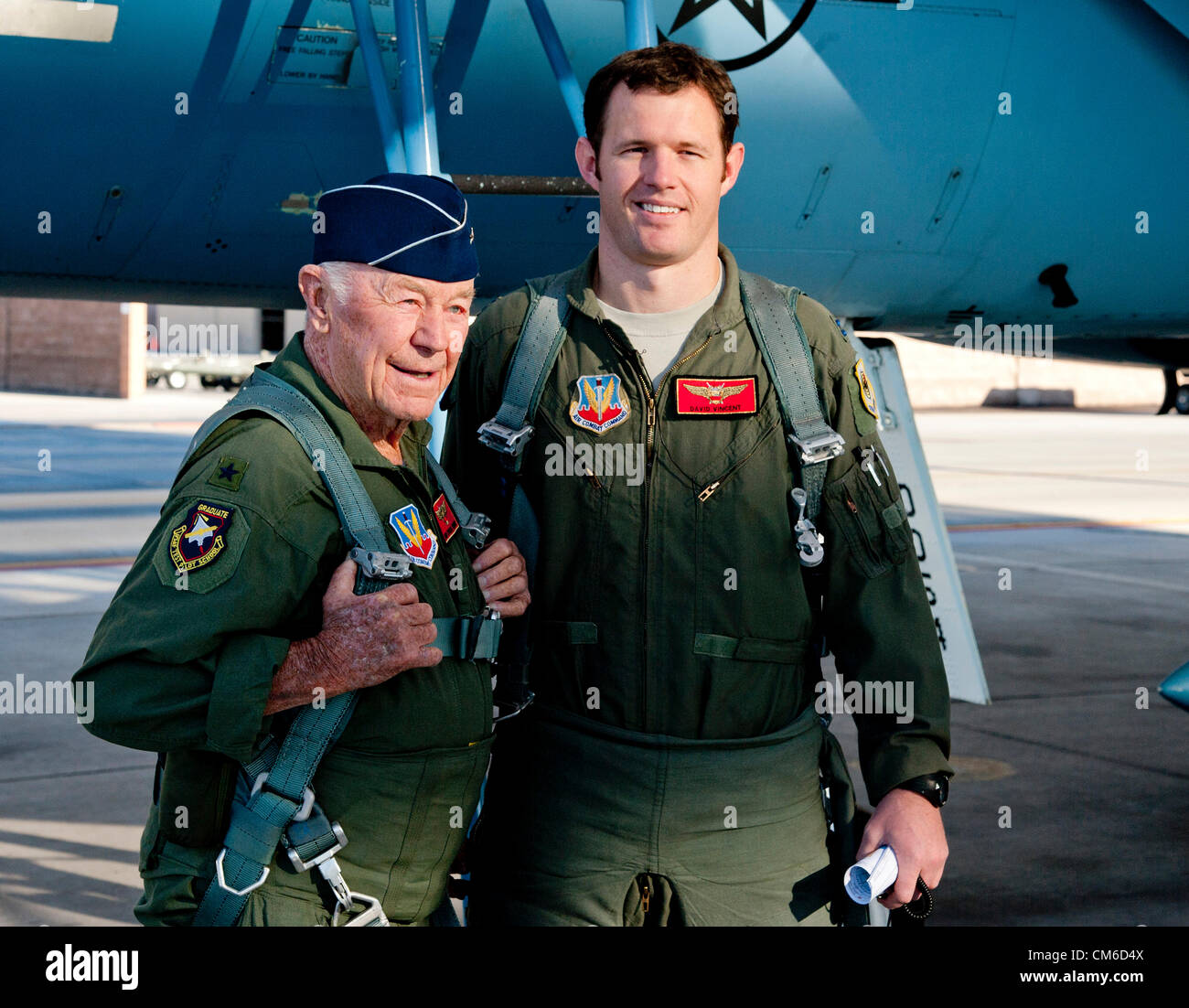 Retired United States Air Force Brig. Gen. Chuck Yeager, 89, with Air Force pilot Capt. David Vincent before boarding an F-15D Eagle fighter aircraft to celebrate the 65th anniversary of becoming the first person to break the sound barrier October 14, 2012, at Nellis Air Force Base, Nevada. In 1947 Yeager broke the sound barrier in a Bell XS-1 rocket research plane named Glamorous Glennis. Stock Photo