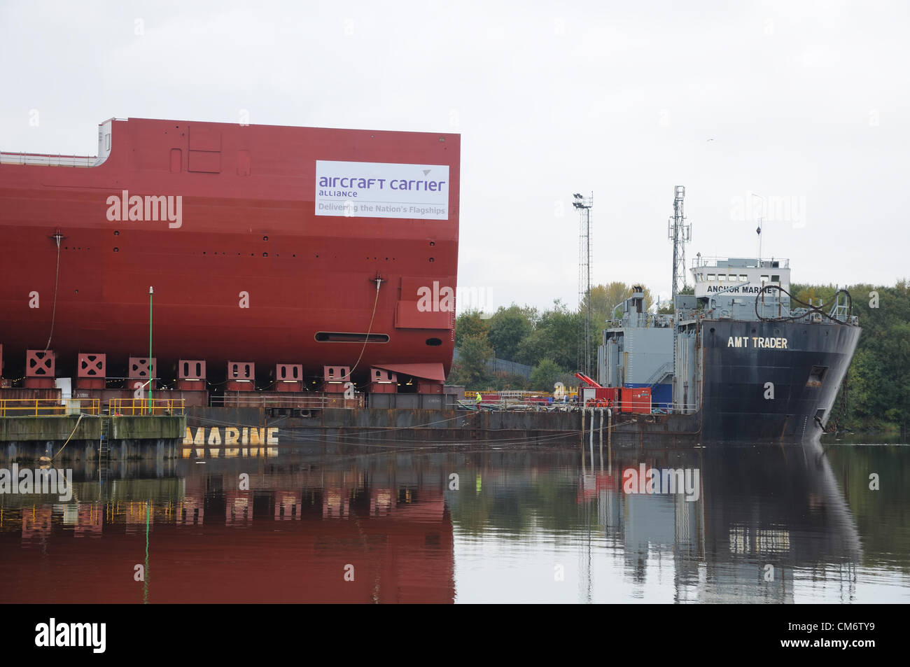 River Clyde, Glasgow, Scotland, UK. 18th October 2012. Latest completed section of the new Royal navy aircraft carrier was carefully loaded onto the AMT Trader barge in preparation for its journey by sea to Rosyth dockyard on the east coast of Scotland. Stock Photo
