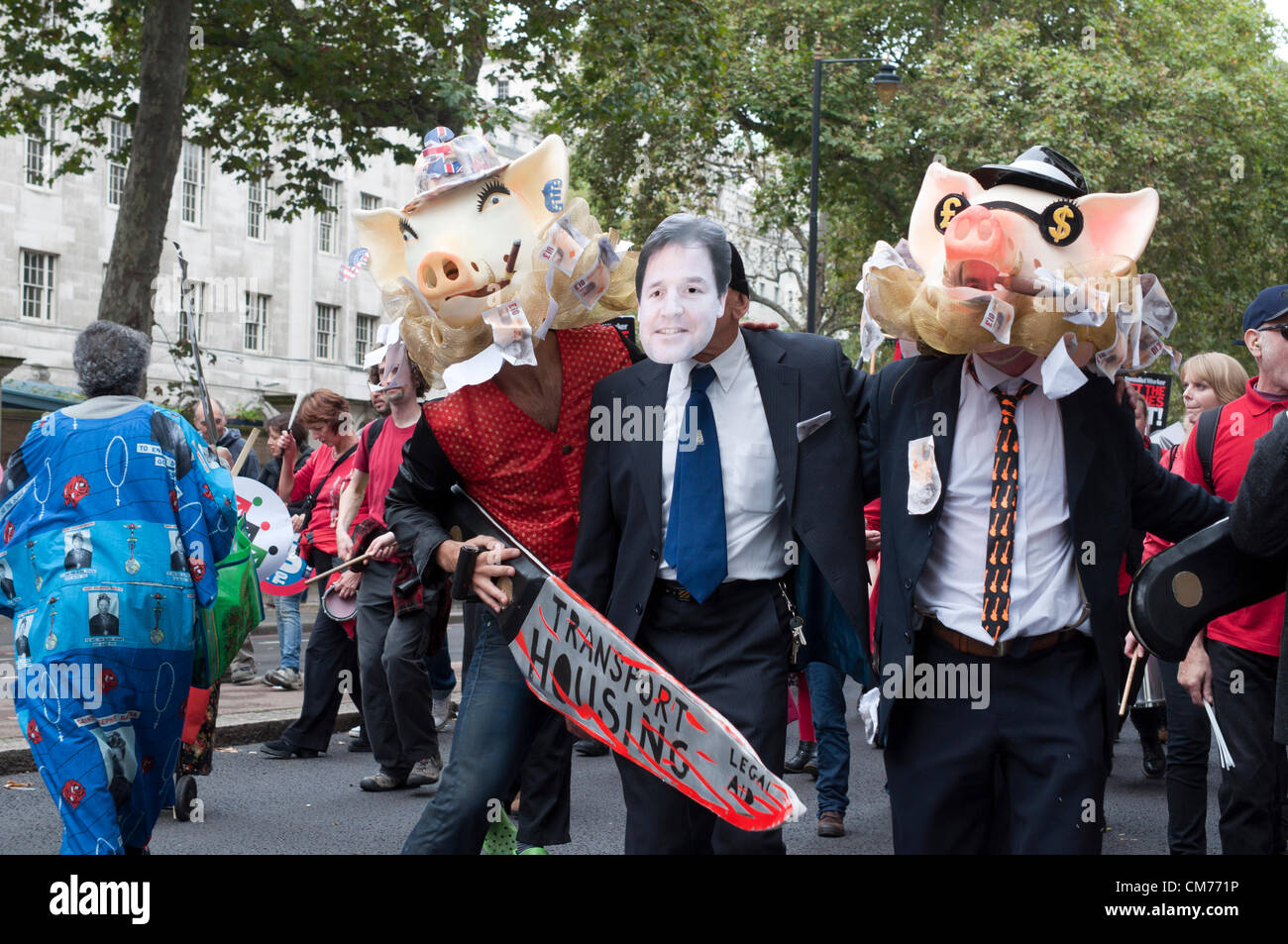 20/10/2012, London UK. Two greedy pigs plus a man wearing a Nick Clegg mask wield a symbolic bloody knife to illustrate public sector cuts as unions stage a mass protest against the UK government's austerity cuts. A march through central London culminated in a rally in Hyde Park Stock Photo