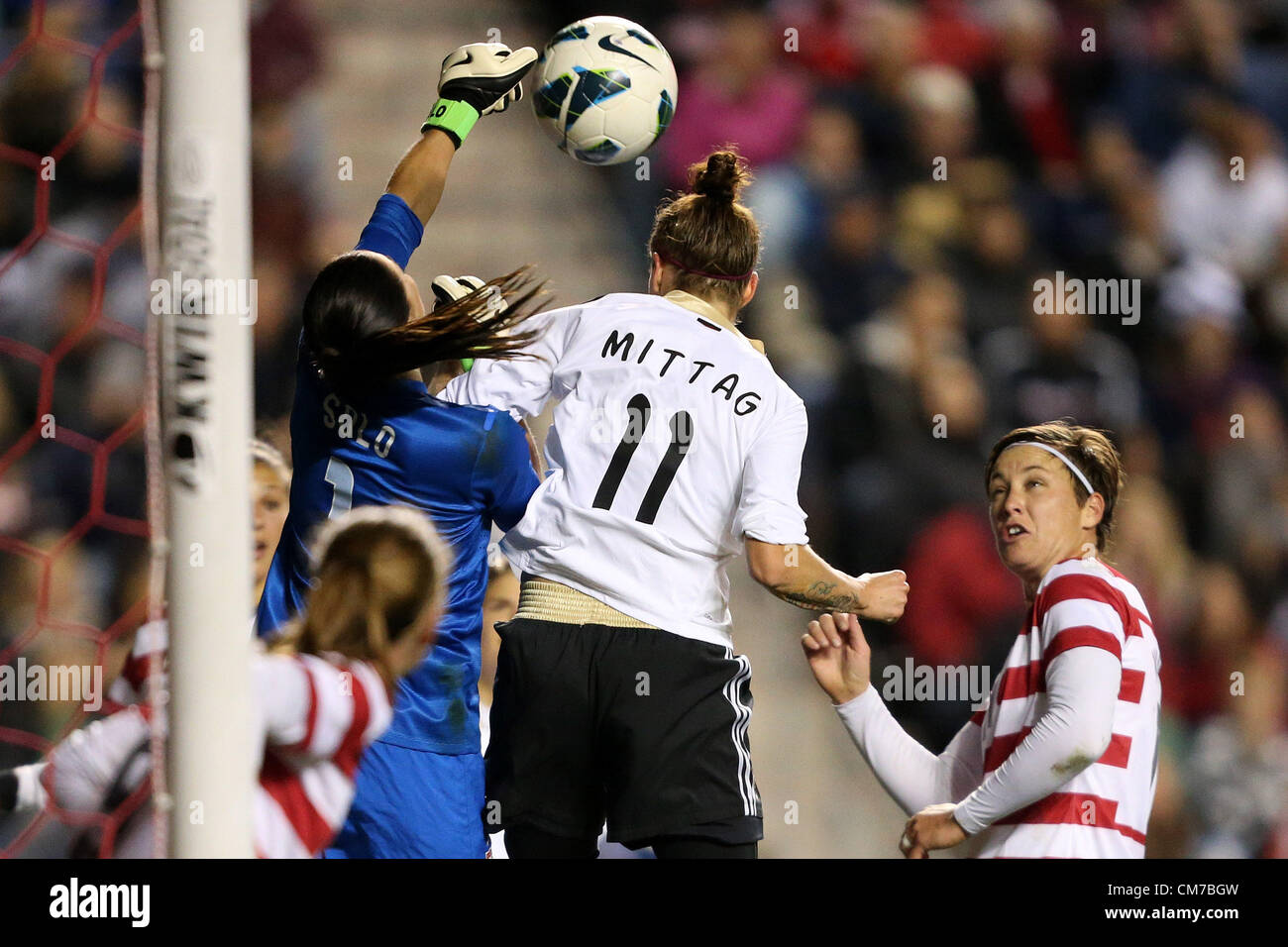 20.10.2012. Chicago, USA.  Hope Solo (USA) (1) punches the ball away from Anja Mittag (GER) (11) and Abby Wambach (USA) (right). The United States Women's National Team played the Germany Women's National Team at Toyota Park in Bridgeview, Illinois in a women's international friendly soccer match. The game ended in a 1-1 tie. Stock Photo