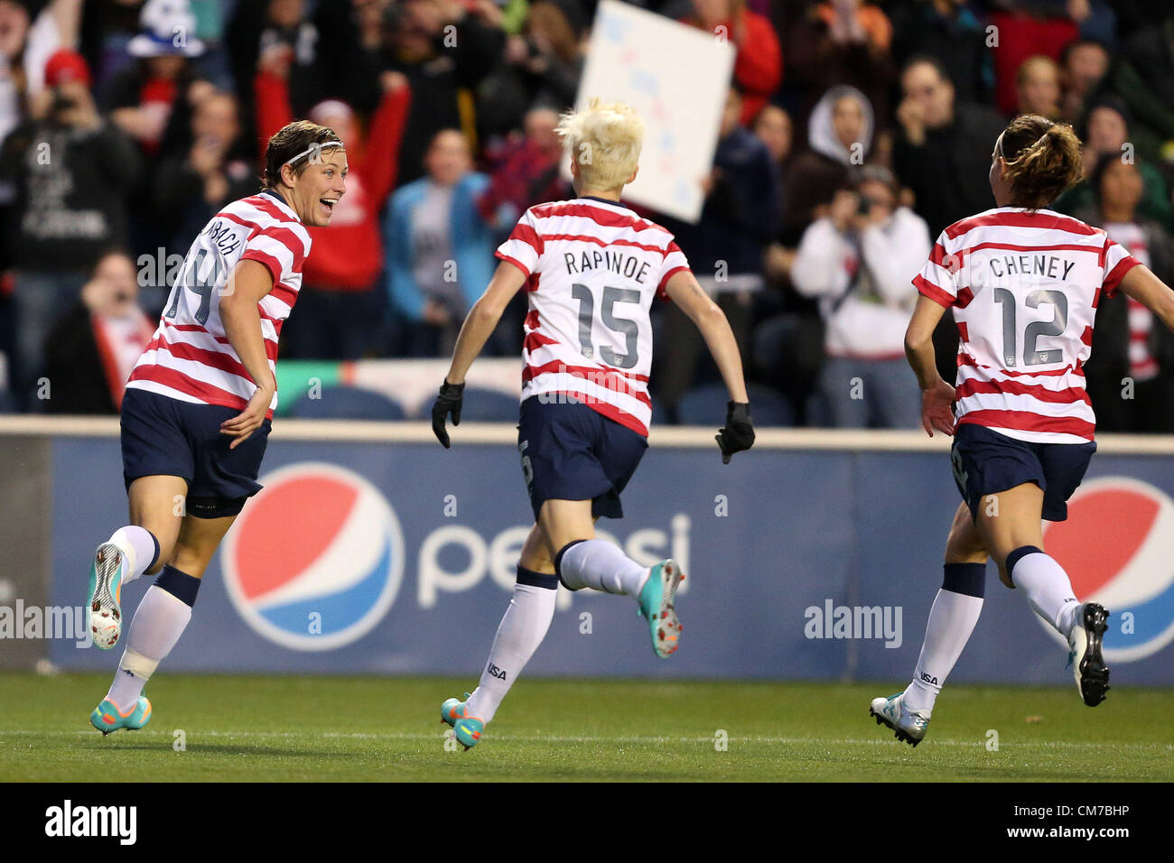 20.10.2012. Chicago, USA.  Abby Wambach (USA) (14) celebrates her goal with Megan Rapinoe (USA) (15) and Lauren Cheney (USA) (12). The United States Women's National Team played the Germany Women's National Team at Toyota Park in Bridgeview, Illinois in a women's international friendly soccer match. The game ended in a 1-1 tie. Stock Photo