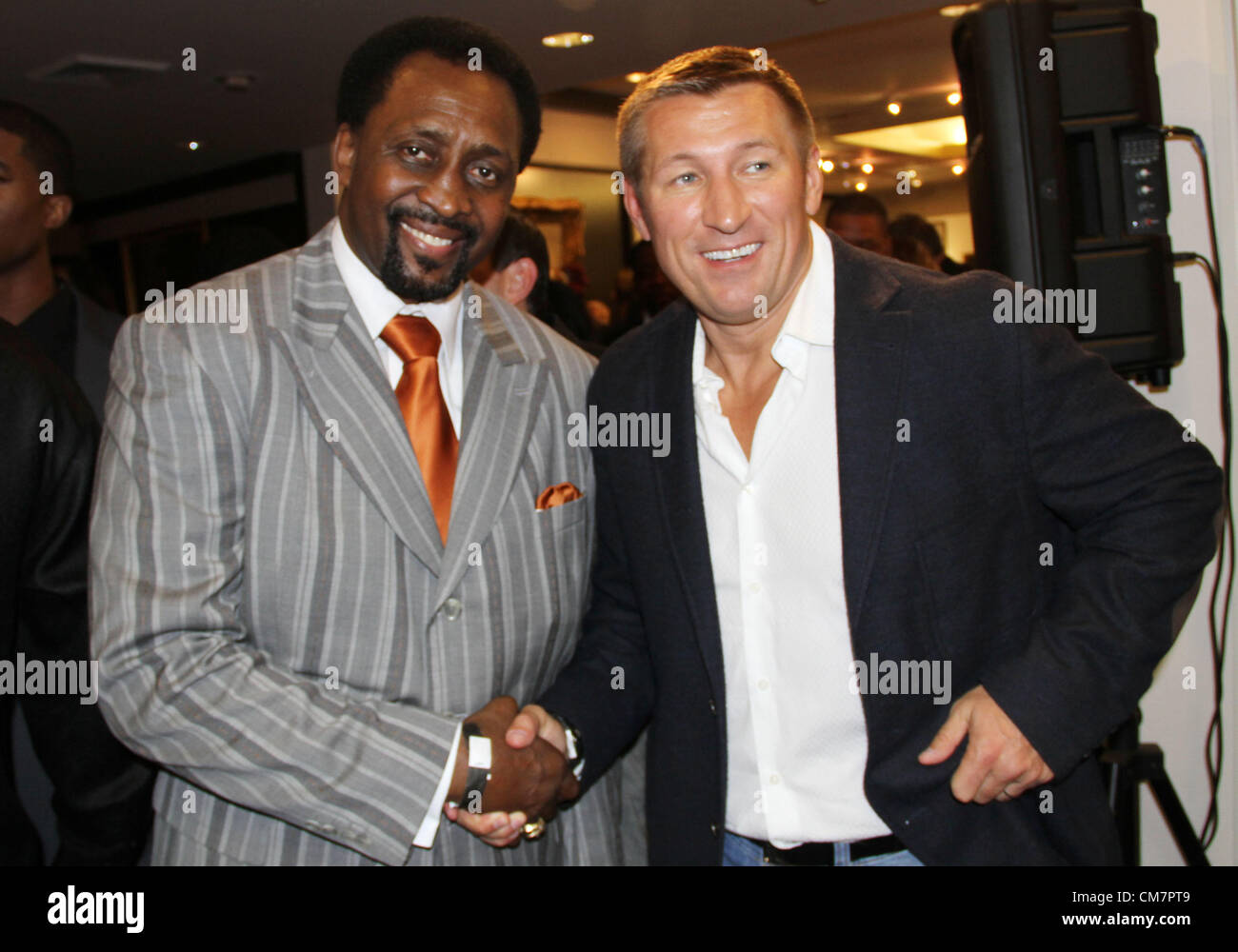 Oct. 19, 2012 - Los Angeles, California, USA - Former Welter Weight Champion Thomas ''The Hitman''   Hearns poses with fan during 50th birthday celebration for   Five time World Heavy Weight Champion Evander ''The Real   Deal'' Holyfield at Julien's Auctions in Beverly Hills, CA. on   Friday October 19, 2012. (Credit Image: © Burt Harris/Prensa Internacional/ZUMAPRESS.com) Stock Photo