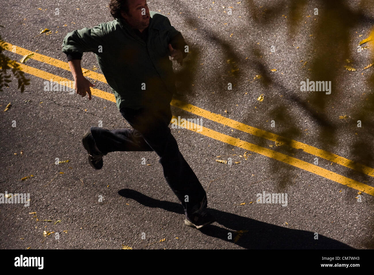 New York, USA. October 22nd 2012. O Positive Films. Actor in a running scene that is filming on location on Wadsworth Avenue in the Inwood neighborhood of Manhattan in New York City Stock Photo