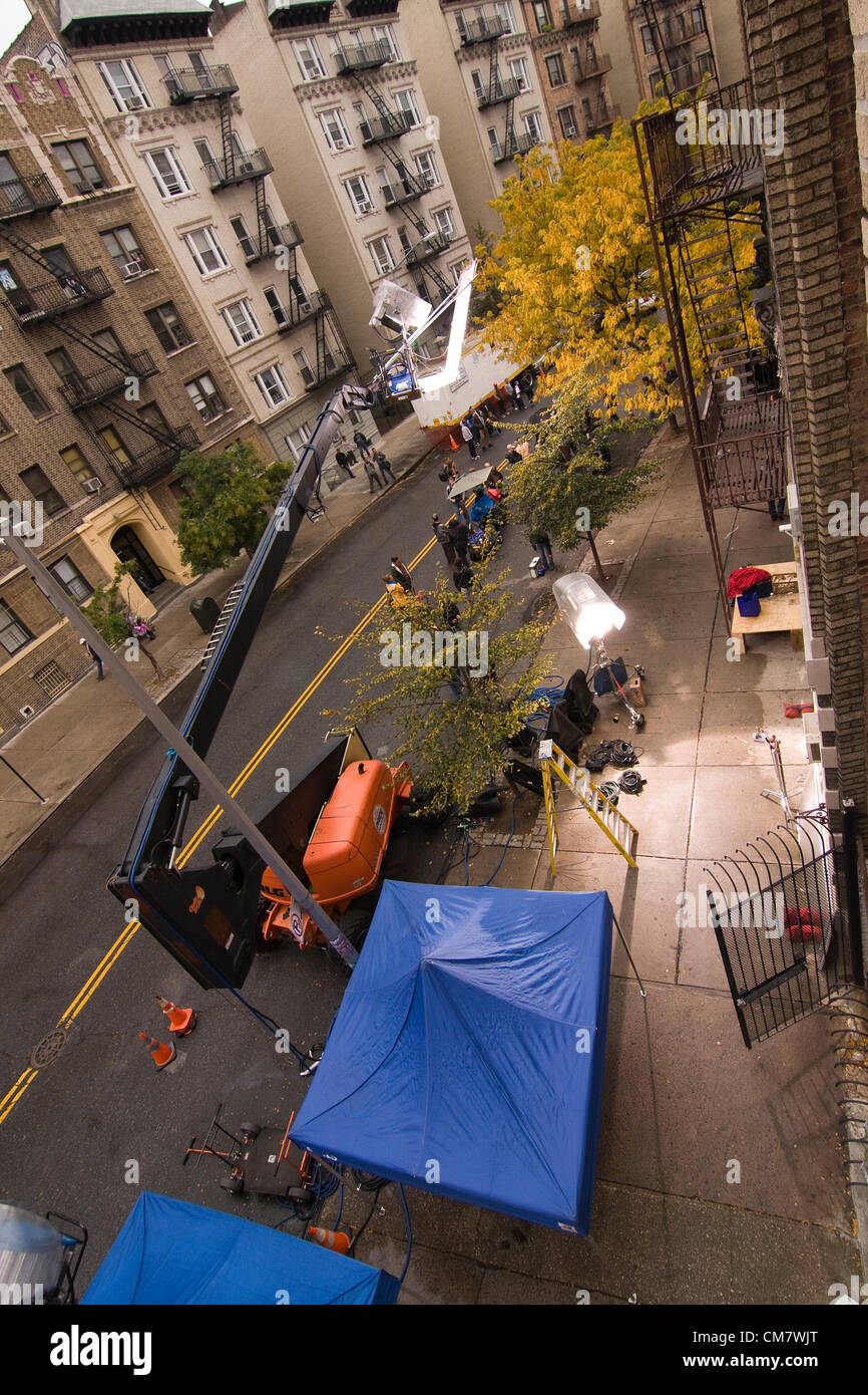 New York, USA. October 23rd 2012. O Positive Films. Aerial View of two large spotlights illuminating the on location set of a movie whilst spectators watch the film crew working on Wadsworth Avenue in the Inwood neighborhood of Manhattan in New York City Stock Photo