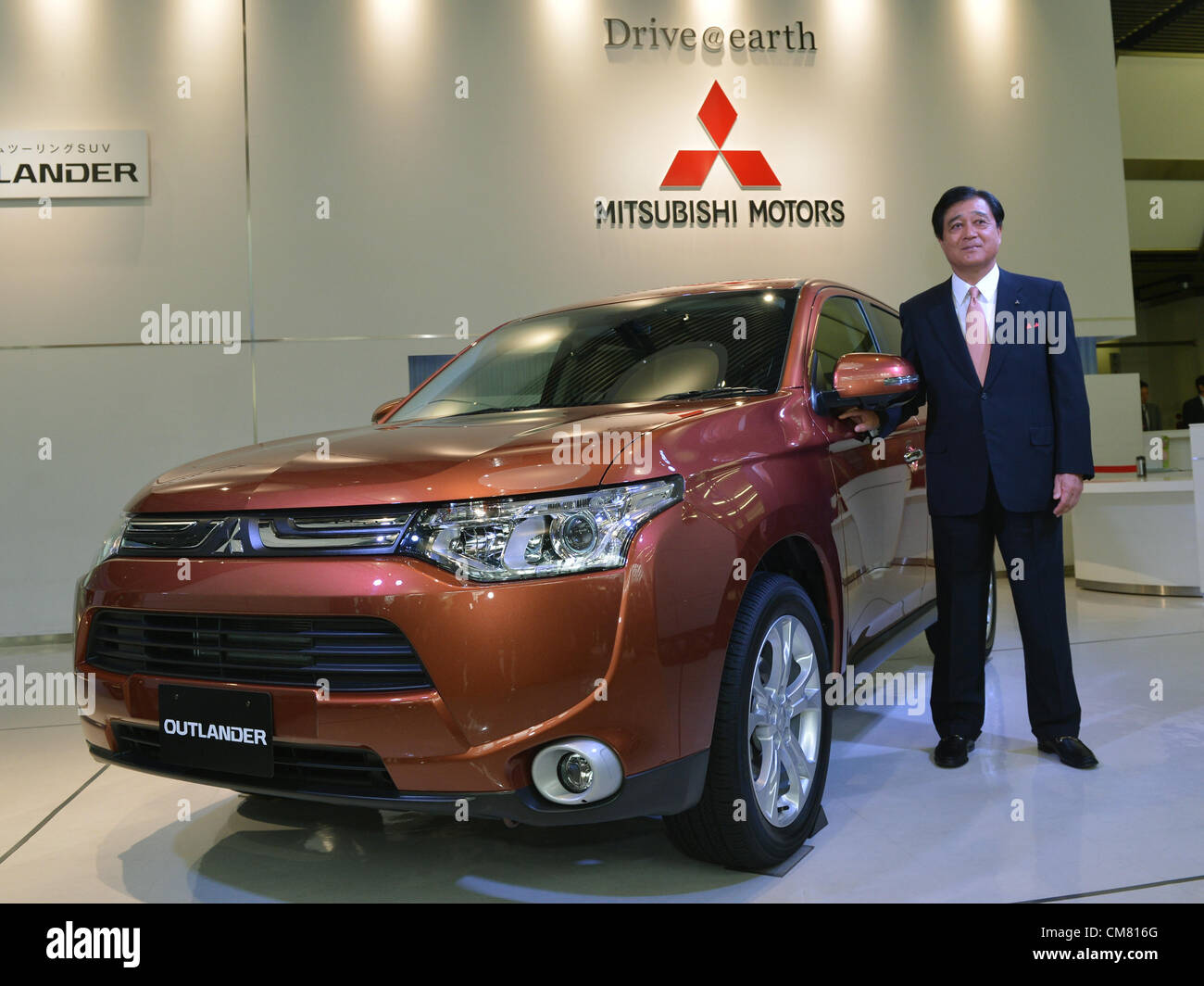 October 25, 2012, Tokyo, Japan - President Osamu Mashiko of Mitsubishi Motors poses with the all new SUV Outlander during a launch at its head office in Tokyo on Thursday, October 25, 2012. The new Outlander comes in a 2.4-liter four-wheel-drive model and a 2.0-liter two-wheel-drive version. (Photo by Natsuki Sakai/AFLO) AYF -mis- Stock Photo