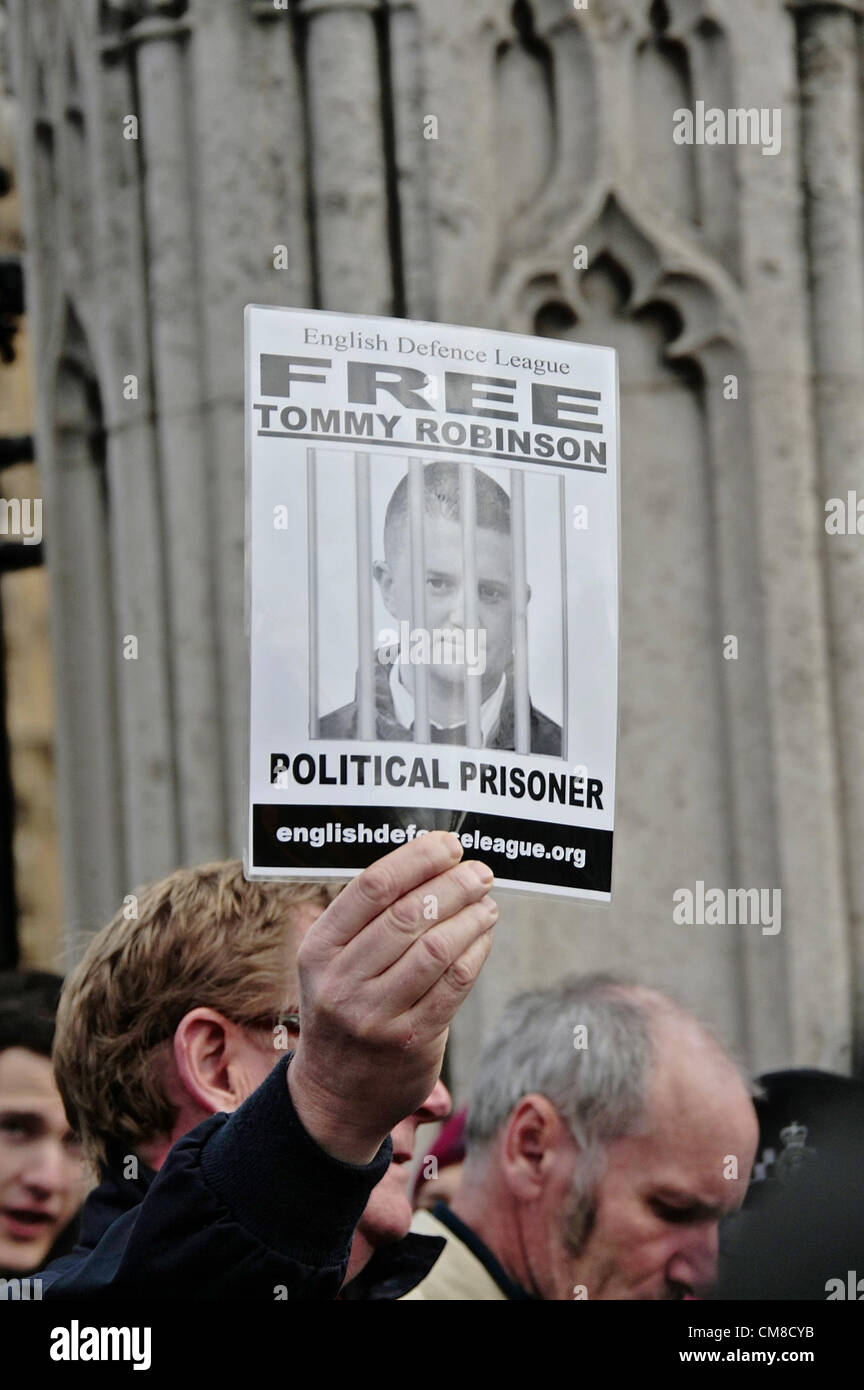 An EDL member hold a placard in support of EDL leader Tommy Robinson currently on remand awaiting trial after being arrested recently. Stock Photo
