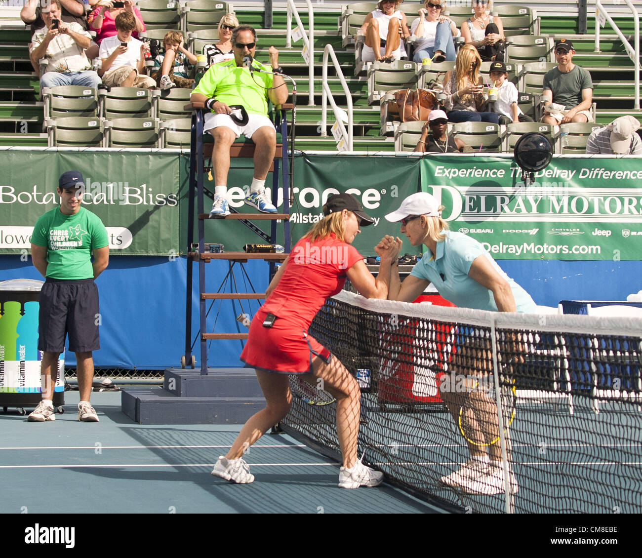 Oct. 27, 2012 - Delray Beach, FL, US - Tennis legend CHRIS EVERT and tennis great MARTINA NAVRATILOVA arm wrestle over the net during their match at the 2012 Chris Evert Pro-Celebrity Classic at the Delray Beach Tennis Center, Delray Beach, Florida. Comedian JON LOVITZ, in the umpires chair, and a ballboy watch. (Credit Image: © Arnold Drapkin/ZUMAPRESS.com) Stock Photo
