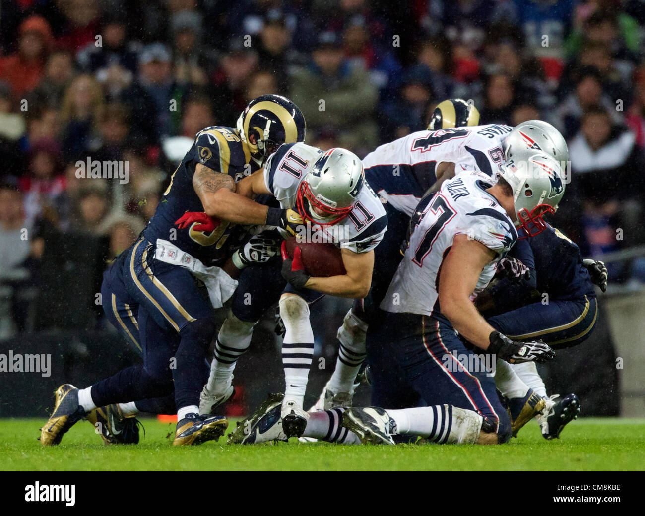 28.10.2012 London, England. NE Patriots WR Wes Welker is tackled by The  Rams Defence during the NFL International Series 2012 game between The Bill  Belichick and Tom Brady led New England Patriots