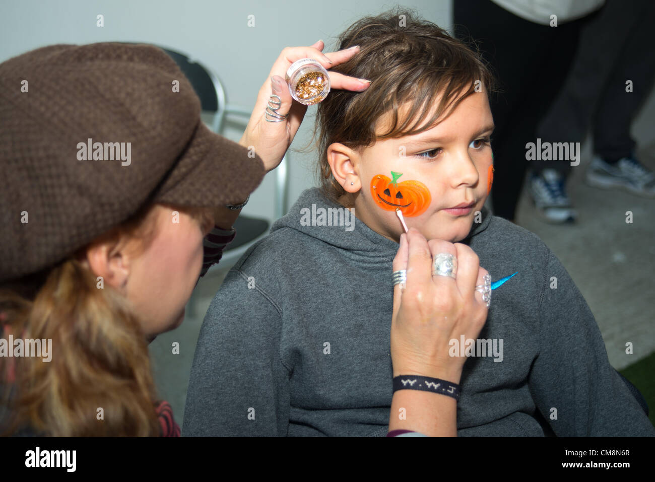 Young girls having Halloween-themed face painting, St Austell, Cornwall. Stock Photo