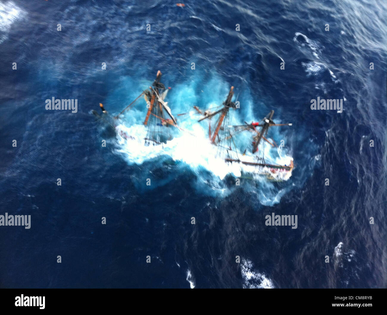 The HMS Bounty, a 180-foot replica 18th century sailing vessel sinks in the Atlantic Ocean during Hurricane Sandy October 29, 2012 90 miles southeast of Hatteras, NC. The Coast Guard rescued 14 crew members by helicopter. The body of a crew member was recovered, and one was still missing. Stock Photo