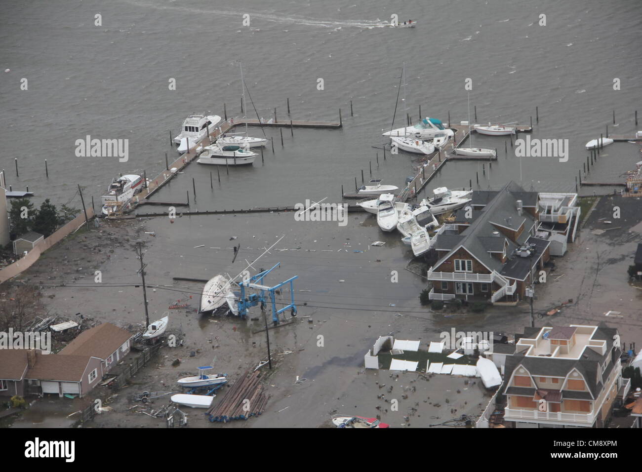 Boats and Homes are displaced in Brigantine, N.J., Oct. 30, 2012, after Hurricane Sandy made landfall on the southern New Jersey coastline, USA Oct. 29, 2012. The photo was taken by a Coast Guard crewmember aboard an MH-65 Dolphin helicopter from Coast Guard Air Station Atlantic City during a flooding assessment over flight. Credit: Archive Image/US Coast Guard Stock Photo