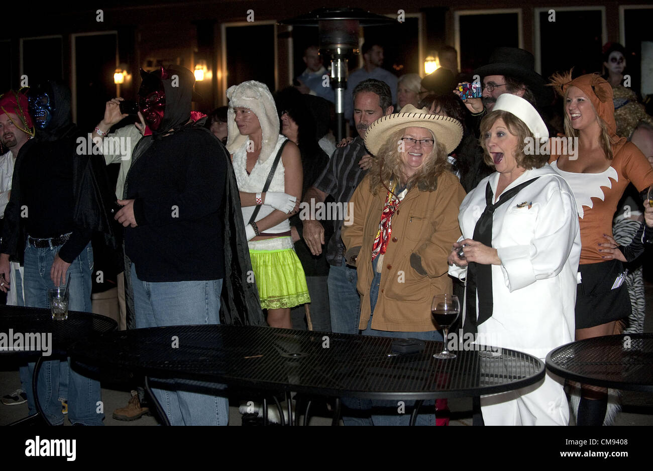 Oct. 26, 2012 - Brighton, Michigan, U.S - A crowd of Halloween partiers react to John Fletcher of Pinckney, aka Ghengis John the Human Firecracker, after he blew himself up with 6000 firecrackers outside Burroughs Tavern in Brighton, MI on Oct 26, 2012. (Credit Image: © Mark Bialek/ZUMAPRESS.com) Stock Photo