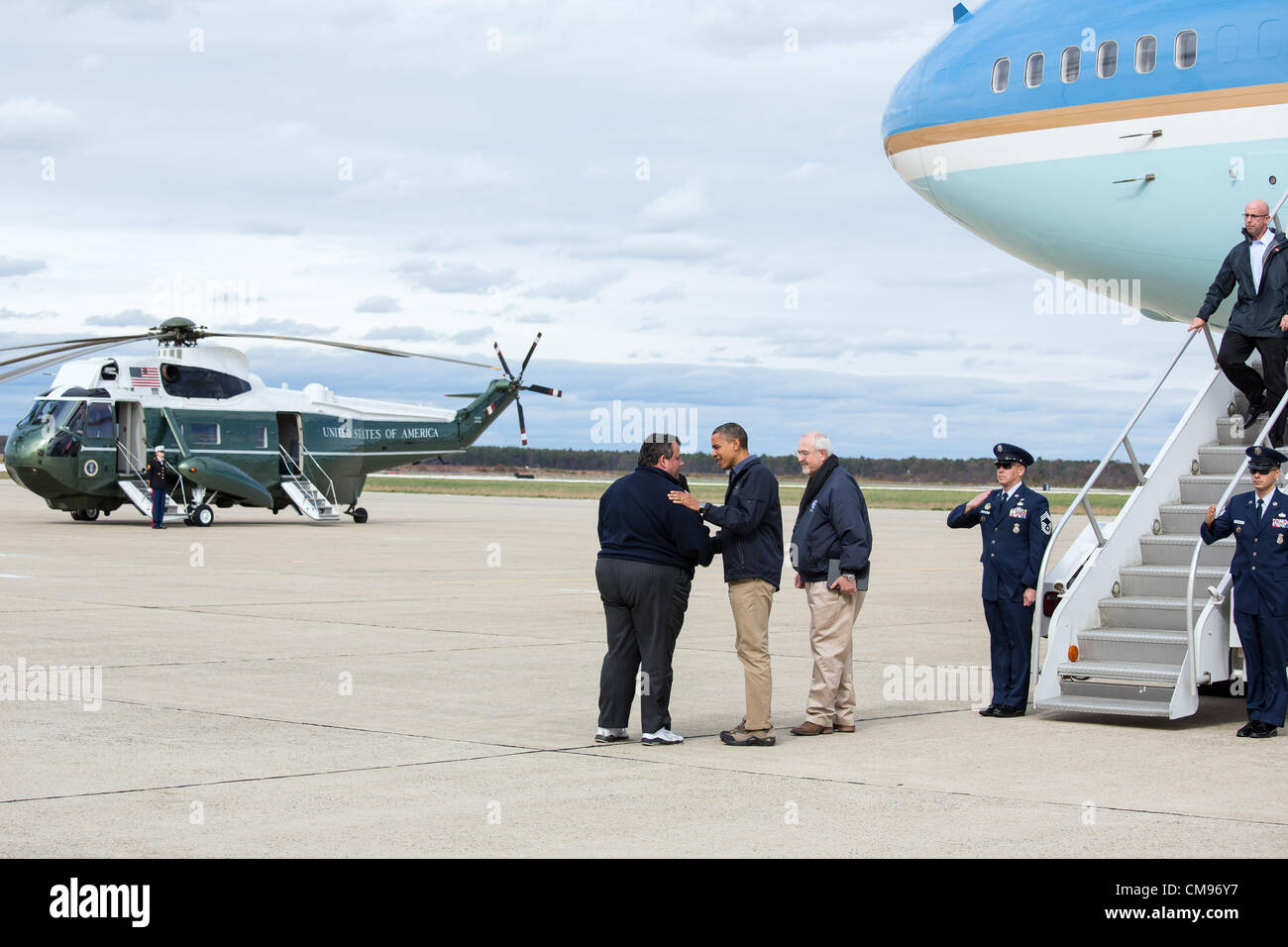 US President Barack Obama and FEMA Administrator Craig Fugate greet New Jersey Gov. Chris Christie on the tarmac of Atlantic City International Airport October 31, 2012 in Atlantic City, N.J. Obama is in New Jersey to view damage from Hurricane Sandy. Stock Photo