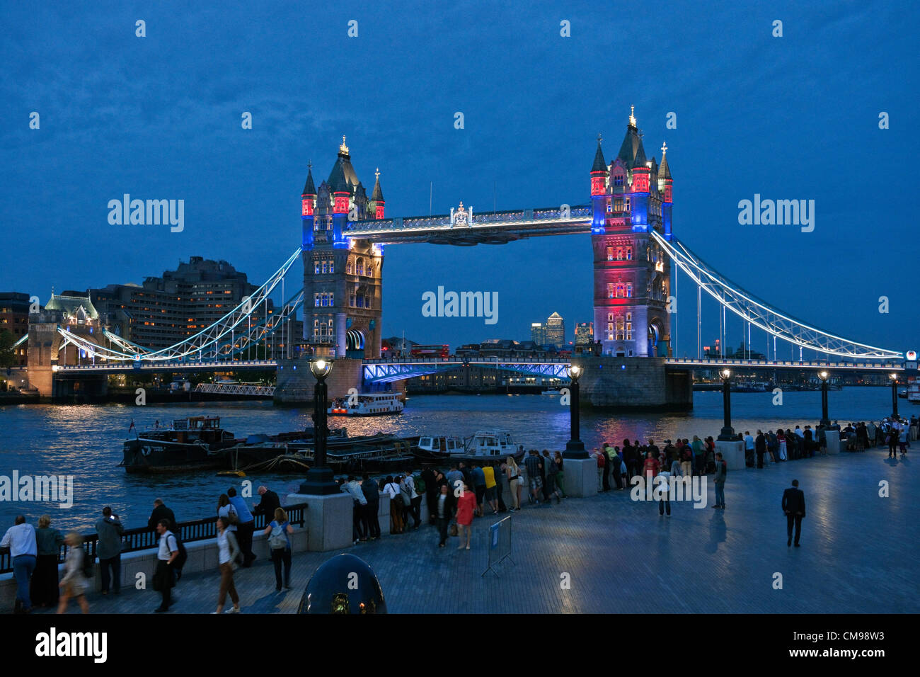London, UK Wednesday27th June 2012. Following the unveiling of the Olympic Rings on Tower Bridge earlier in the day, crowds were treated to a spectacular preview of the light show that will play nightly during the Olympic Games. London is hosting the 30th Summer Olympic Games which begin on July 27th 2012. Stock Photo