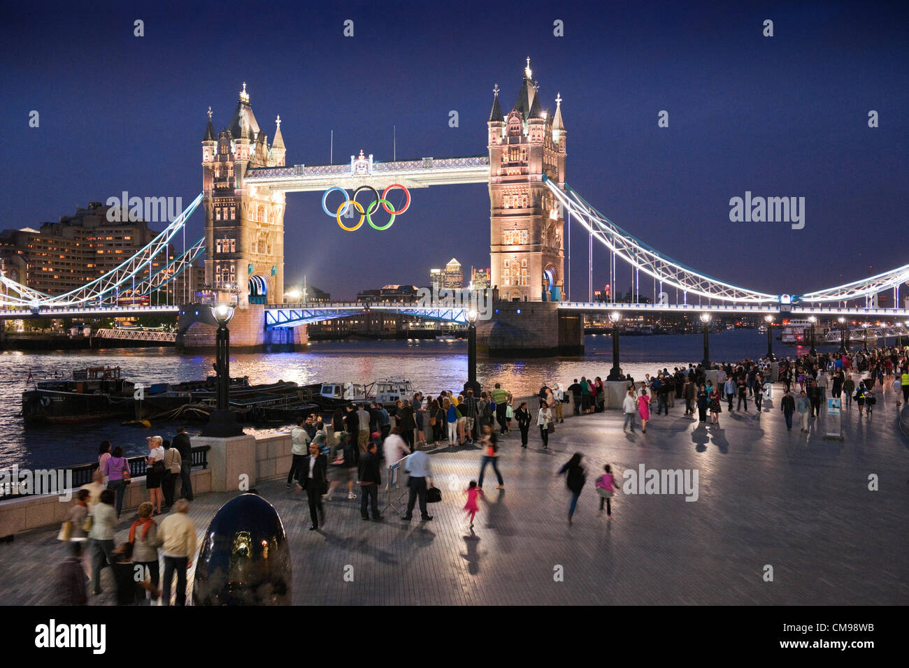 London, UK Wednesday27th June 2012. Following the unveiling of the Olympic Rings on Tower Bridge earlier in the day, crowds were treated to a spectacular preview of the light show that will play nightly during the Olympic Games. London is hosting the 30th Summer Olympic Games which begin on July 27th 2012. Stock Photo