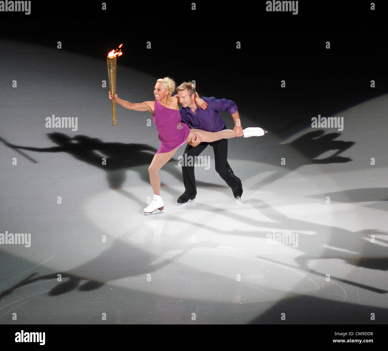 Nottingham, UK. 28 June, 2012. Jayne Torvill OBE and Christopher Dean OBE, 1984 Olympic Dance Champions, take the Olympic flame at the National Ice Centre Stock Photo