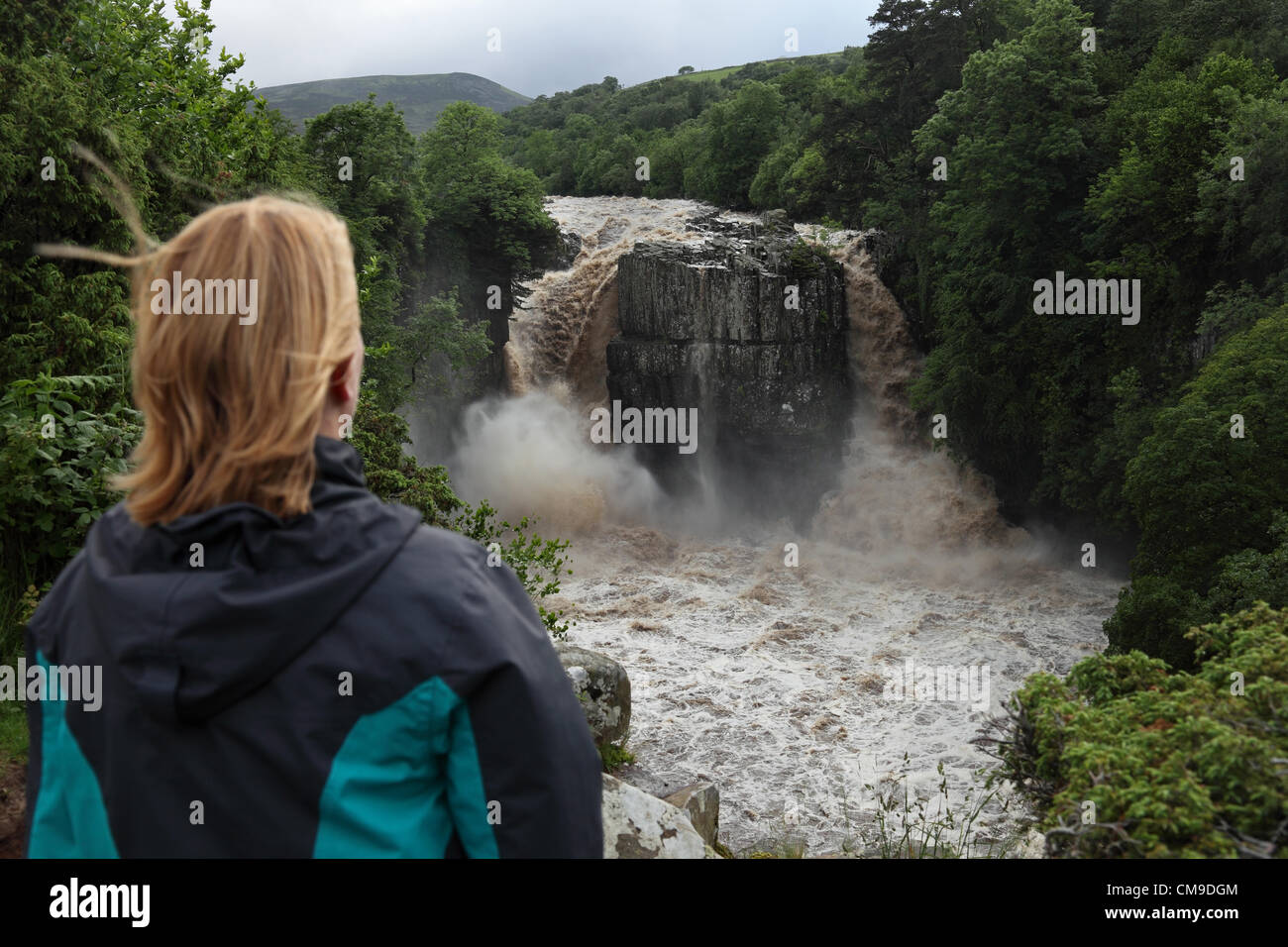 Woman Enjoying the Spectacle of High Force Waterfall on the River Tees, Teesdale, UK on the 28 June, 2012.  After Thunderstorms and Heavy Rain Caused Flash Flooding Throughout North East England. Stock Photo