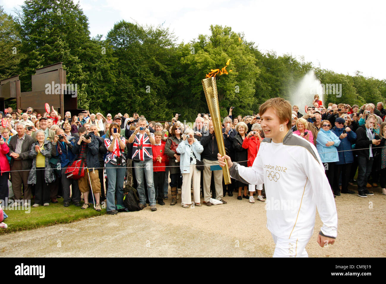 Derbyshire, UK. Friday 29th June 2012. Olympic Torch bearer, Ben Hope, passing through the grounds of Chatsworth House on the Olympics; London2012 Torch relay. Chatsworth is the seat of the Duke of Devonshire and has been home to the Cavendish family since 1549. Stock Photo