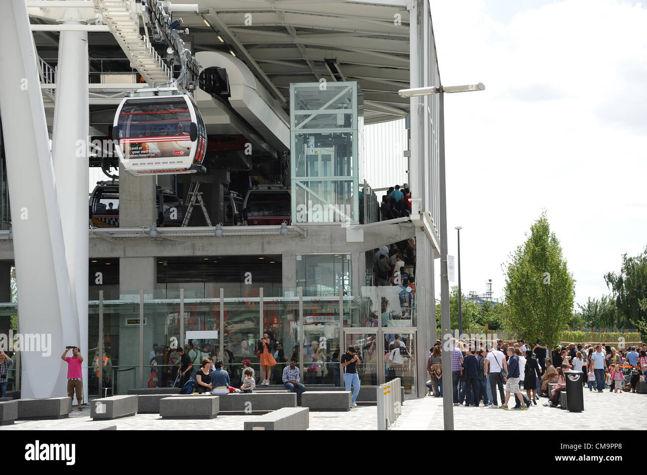 Passengers queue to travel across the Thames between the 02 Arena in   Greenwich and the Excel exhibition centre at the Royal Docks in east London  in Britain's new Thames Cable Cars. 30 June 2012. Stock Photo